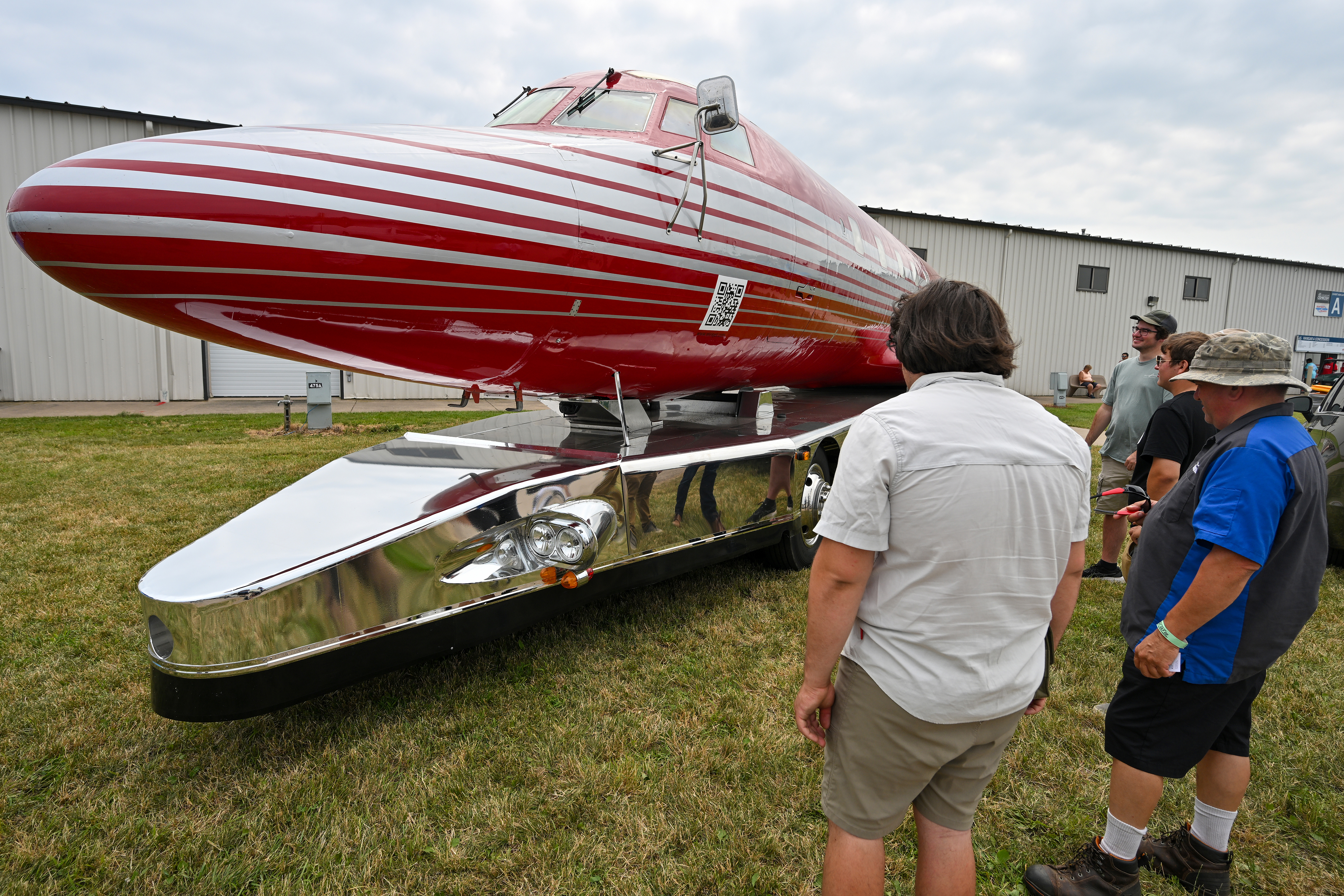 Airplane on wheels builders Gino Lucci (right) and his son Giacinto admire the Jimmy’s World 'Elvismobile'. Photo by David Tulis.