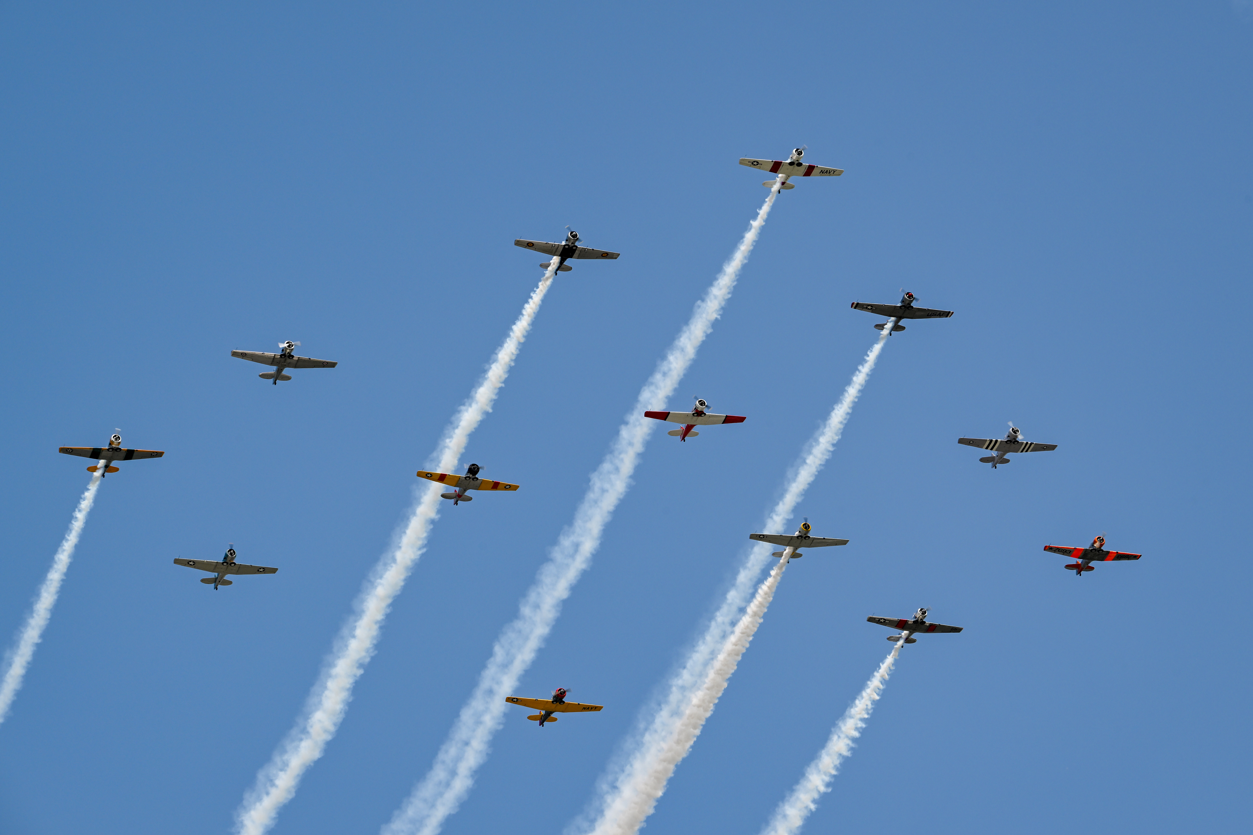 North American T-6 military trainers perform during the opening afternoon airshow. Photo by David Tulis.