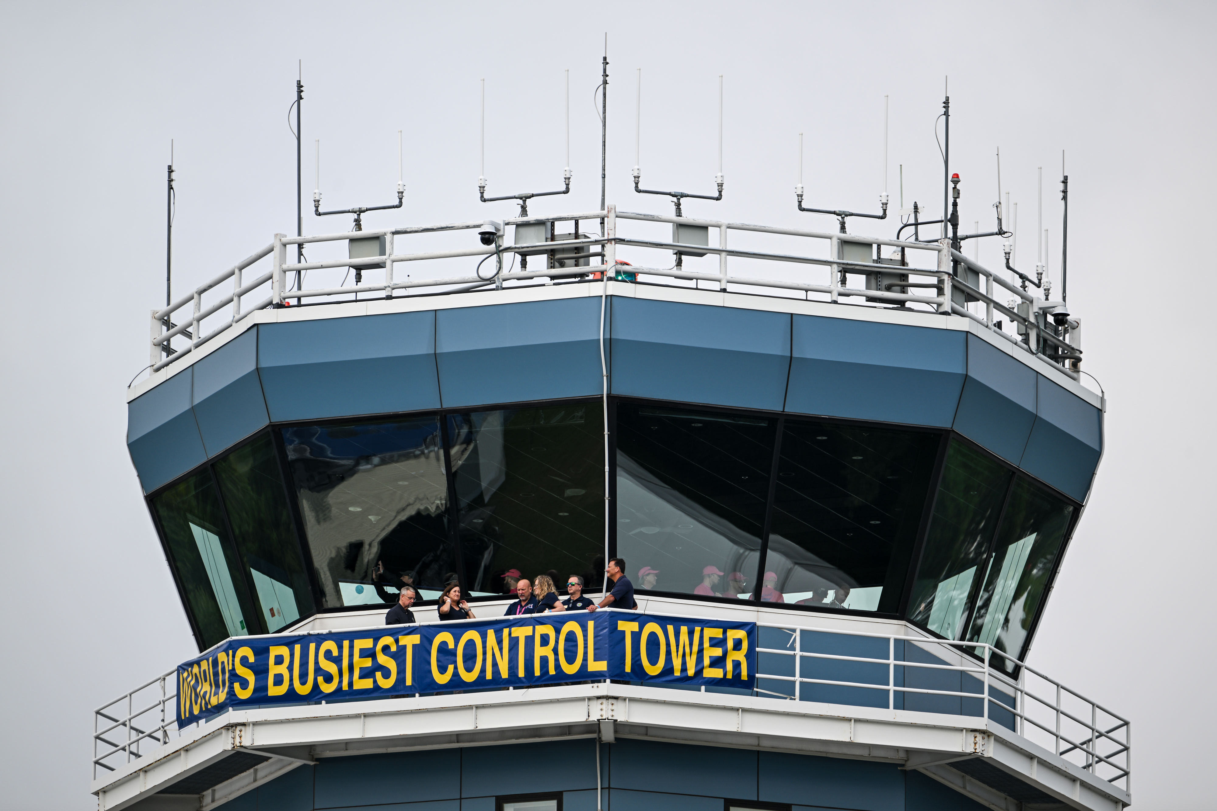 Air traffic controllers and guests sample the view from the 'World’s Busiest Control Tower.' Photo by David Tulis.