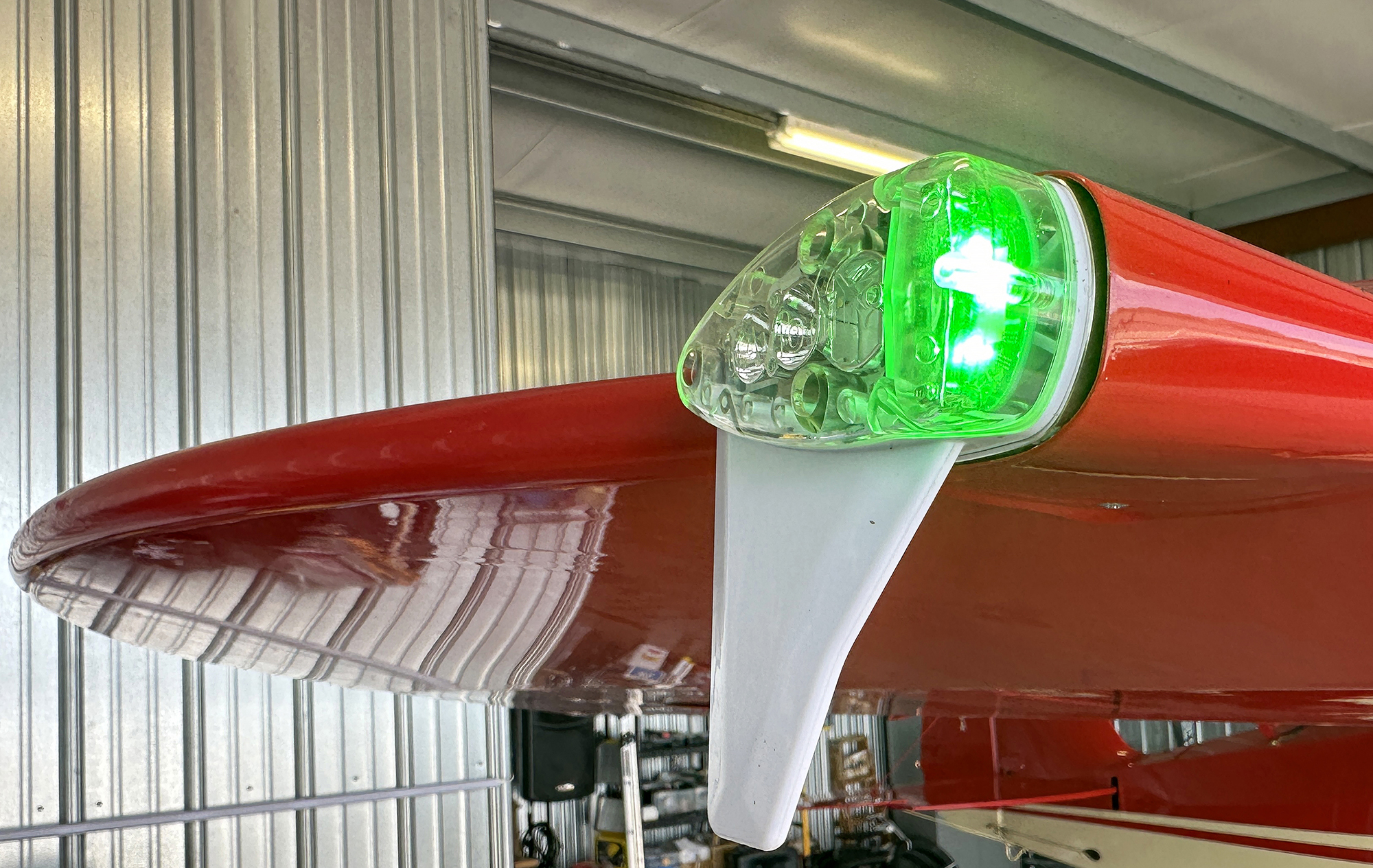 The skySensor by uAvionix brings traffic and weather to certified aircraft via Wi-Fi from a right wingtip LED navigation light and strobe, GPS, and ADS-B receiver installed on a Piper Tri-Pacer. Photo by David Tulis.