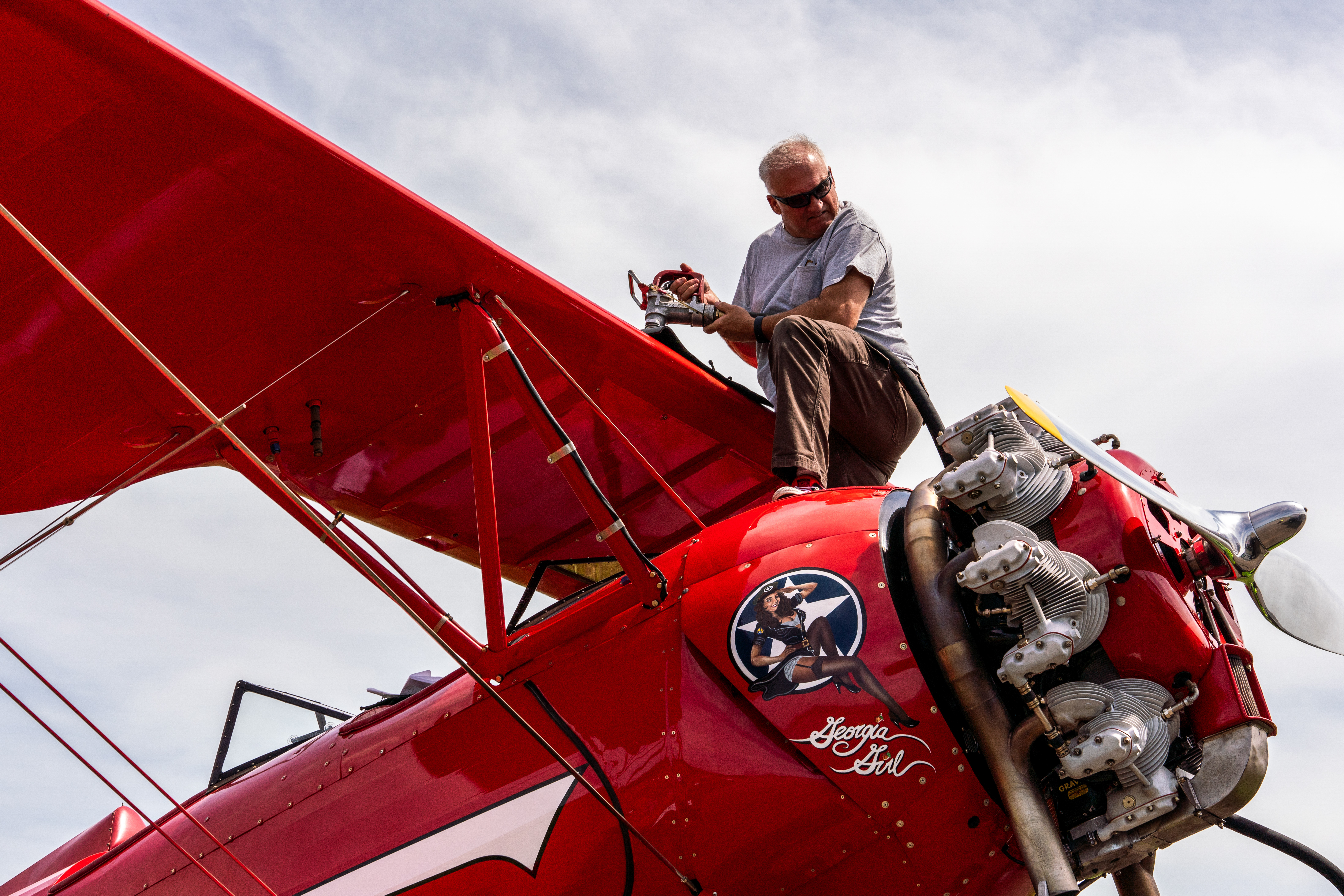 Cliff McSpadden fuels his UPF–7 Waco biplane 'Georgia Girl.' Photo by Jake Teague.