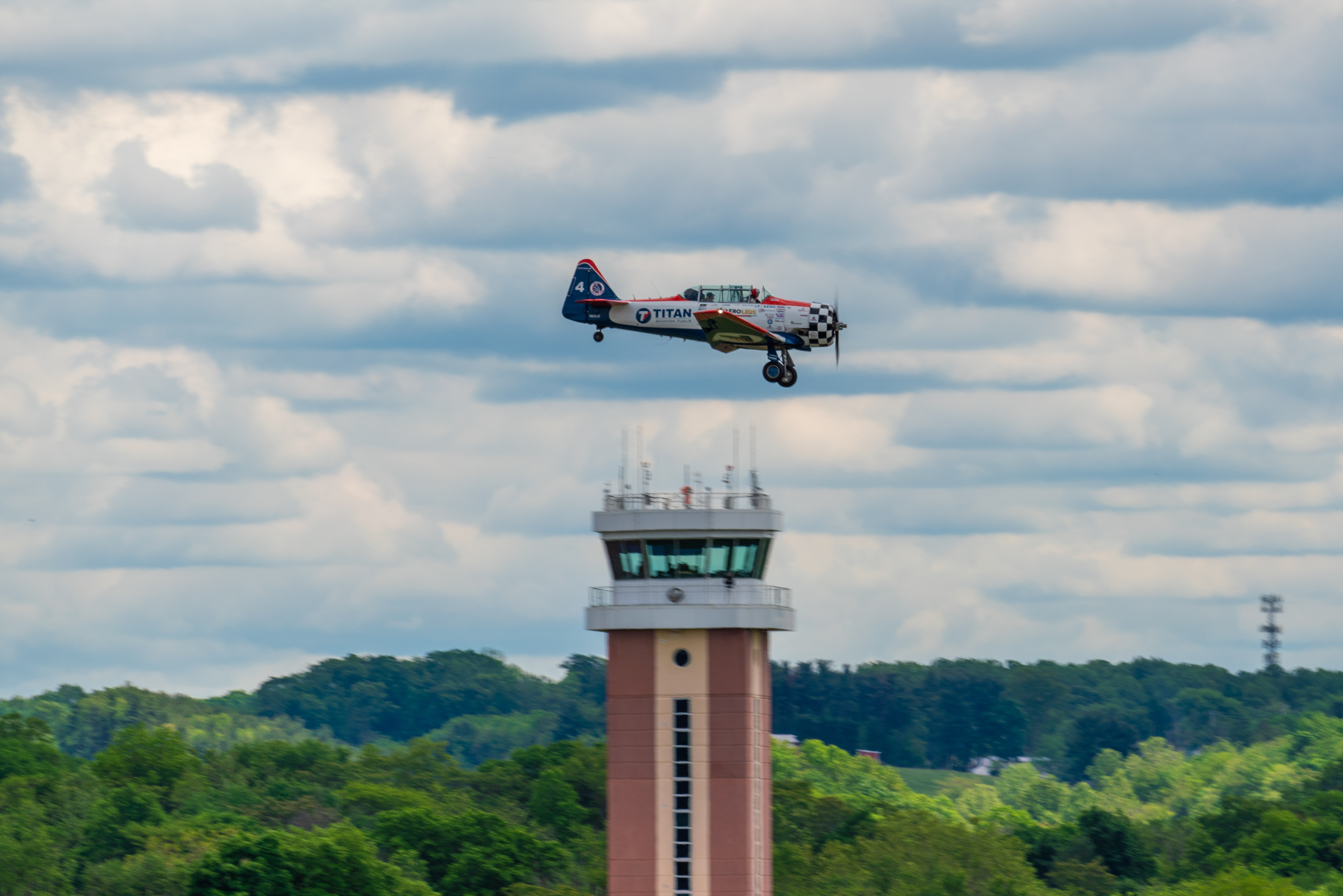 A Titan Aerobatic Team North American T-6 Texan passes the Frederick Municipal Airport tower. Photo by Jake Teague.