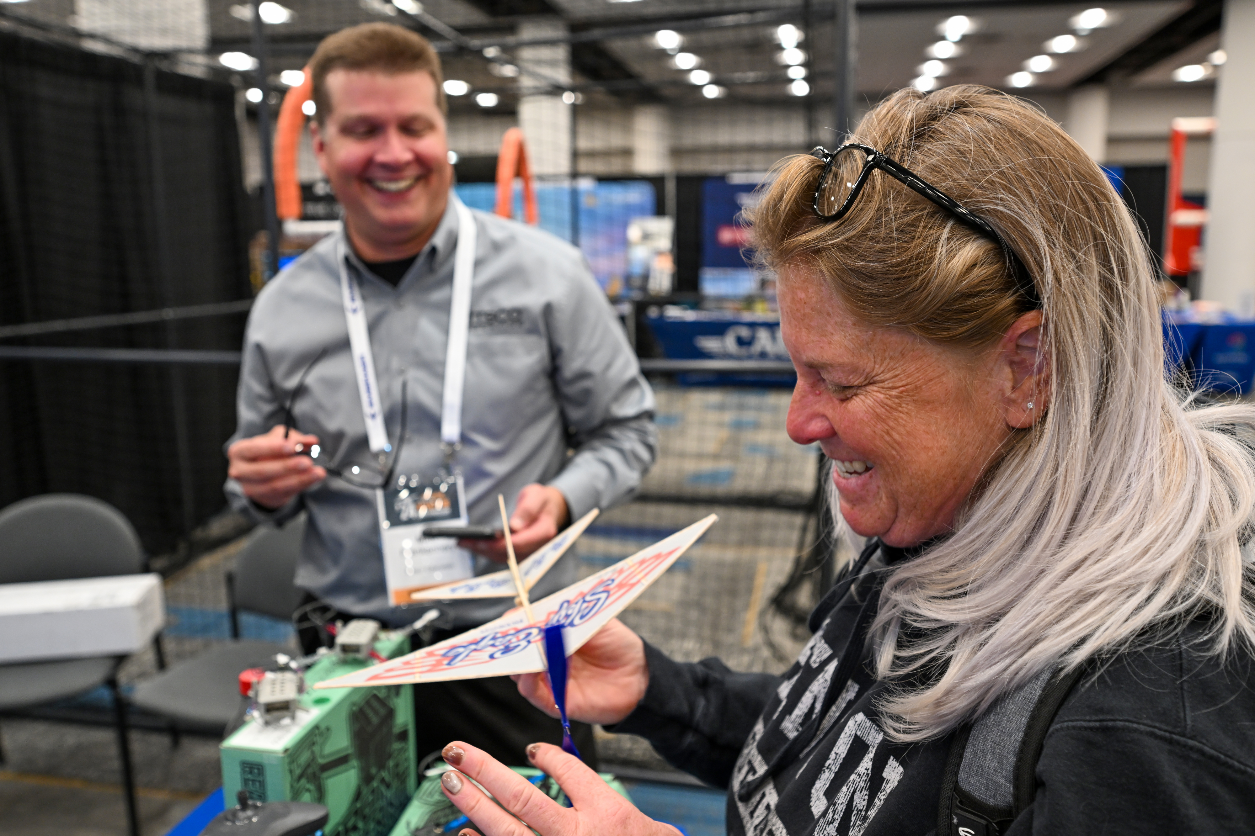 Educator Marion Carlin of Palmyra, New Jersey, checks a balsa wood glider from Pitsco in the exhibit hall. Photo by David Tulis.