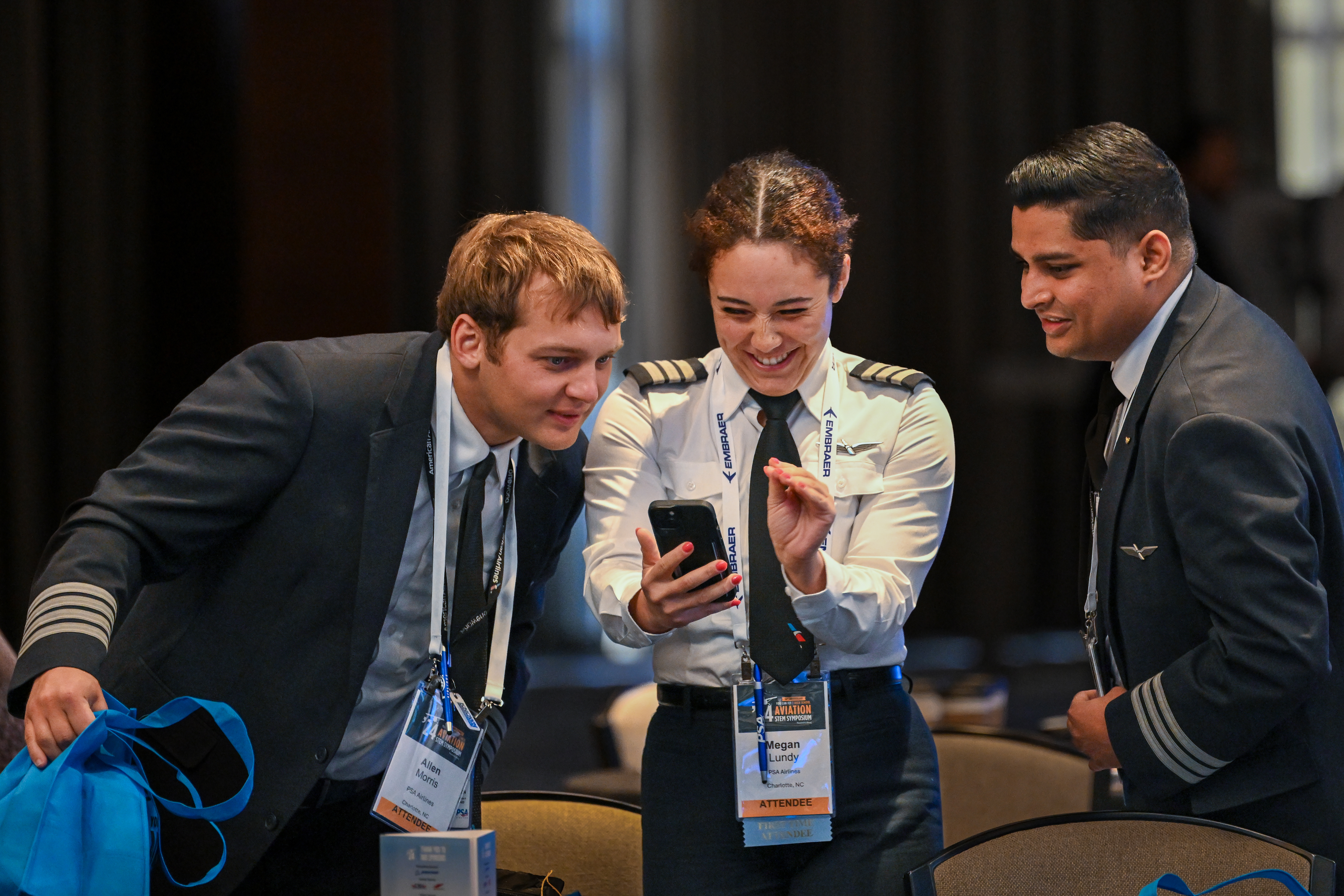 Megan Lundy of PSA Airlines, center, joins colleagues during the AOPA High School Aviation STEM Symposium. Photo by David Tulis.