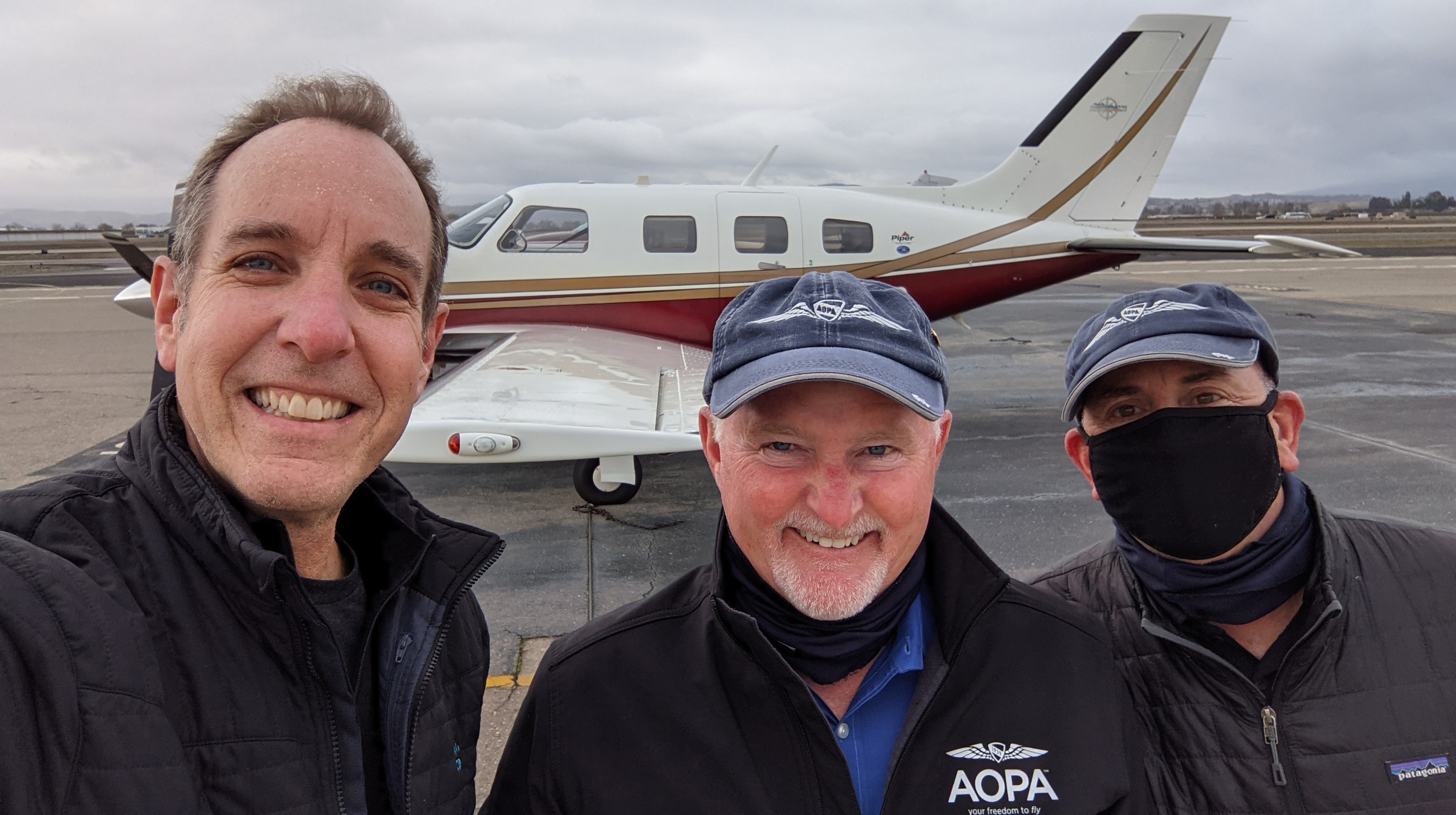 Darren Pleasance conspired with AOPA President Mark Baker (center) and Editor at Large Dave Hirschman to spring a sweepstakes surprise in 2021, when the association awarded a Van’s Aircraft RV-10 to a California pilot who is a college friend of Pleasance.