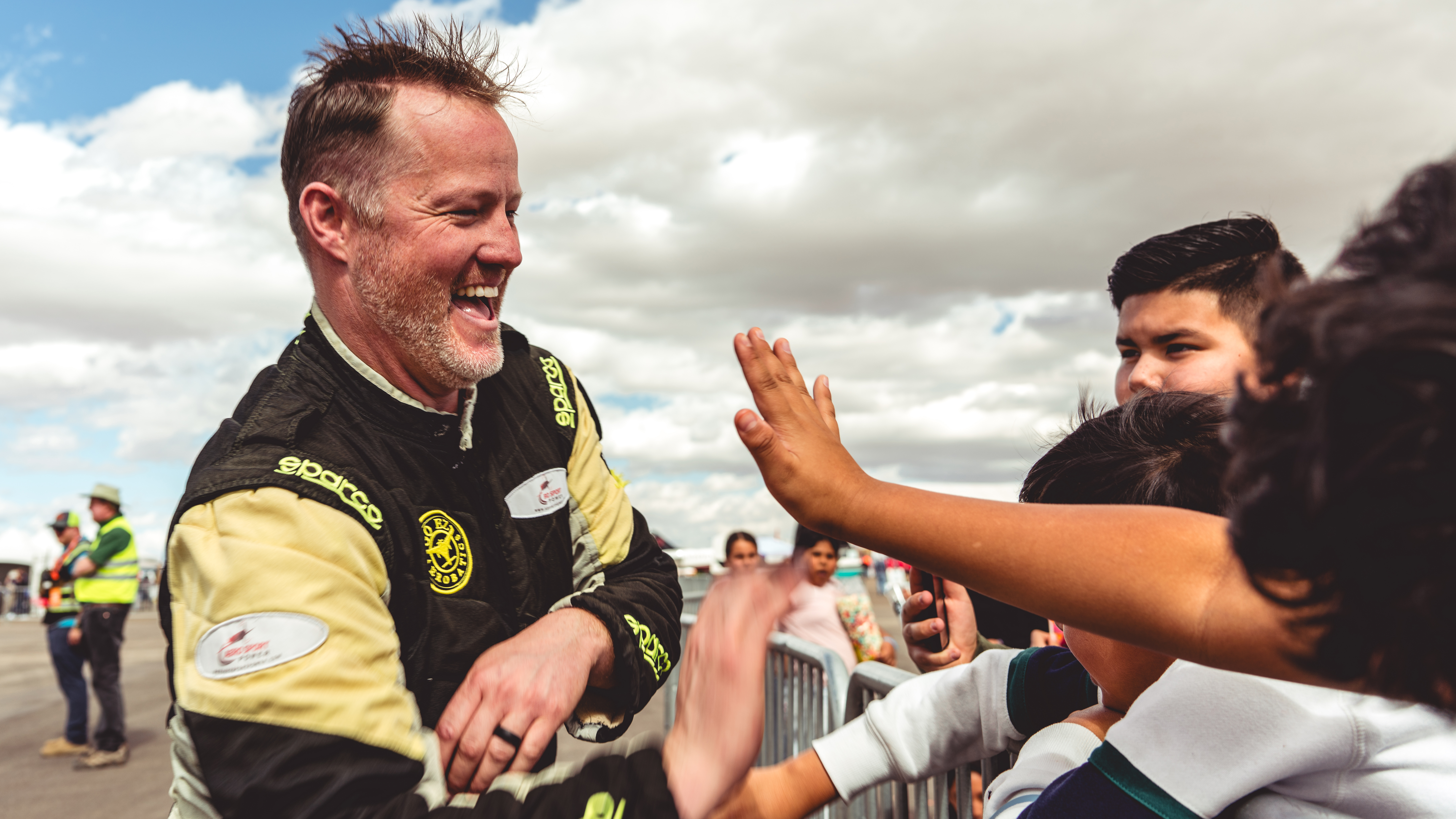 Kyle Fowler from Go EZ Aerobatics greets kids on Field Trip Friday. Photo by Jake Teague.