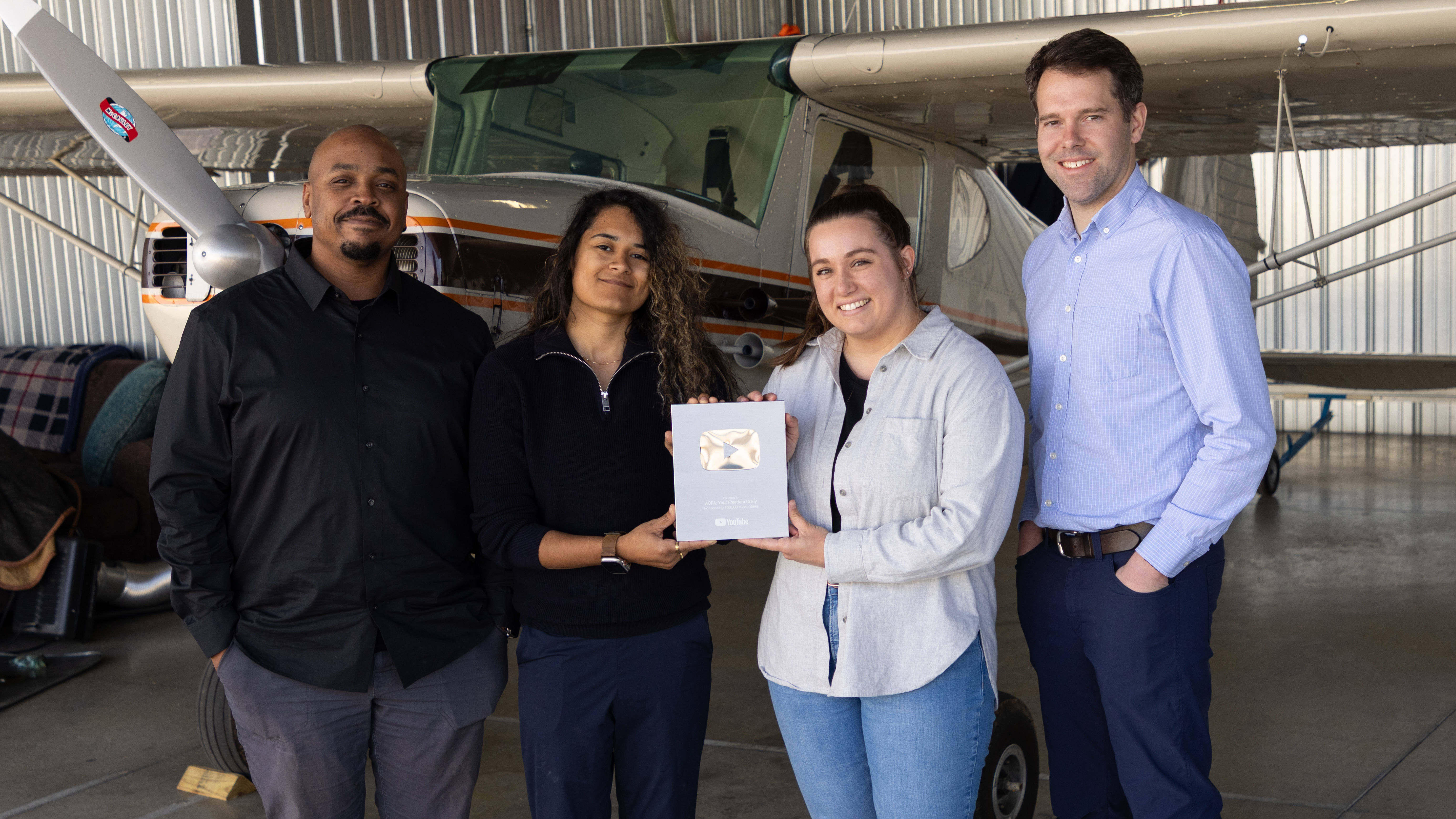 Holding the plaque from left to right are content producers Jamal Warner, Brianna Cabassa,  and Michelle Walker, and Video Manager Josh Cochran. Photo by Rebecca Boone.
