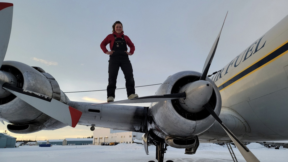Mikaela Young stands on the blade of an Everts Air Cargo aircraft. Photo courtesy of Mikaela Young.