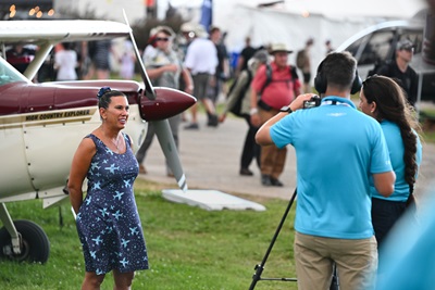 Jennifer Hortman is interviewed during a ruse before accepting the AOPA Sweepstakes Cessna 182. Photo by David Tulis.