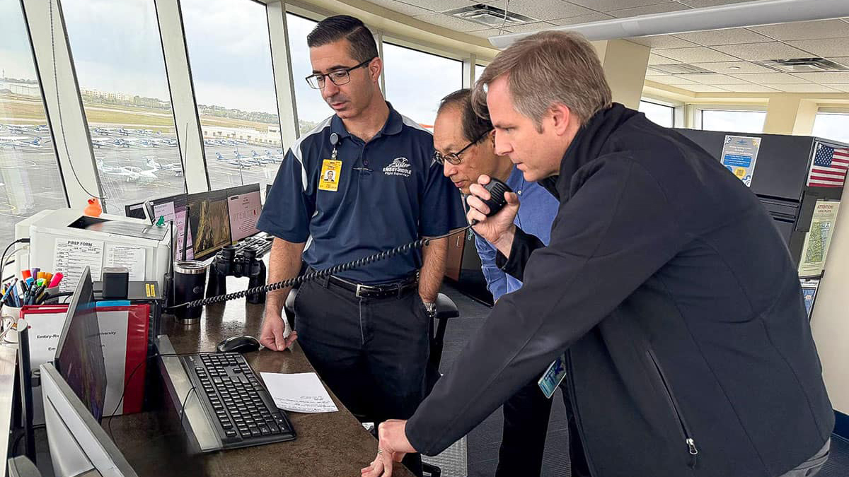 Andrew Schneider and Jianhua Liu join Lead Flight Supervisor Chris Deputy, left, in the tower. Photo courtesy of Embry-Riddle/Melanie Stawicki Azam.