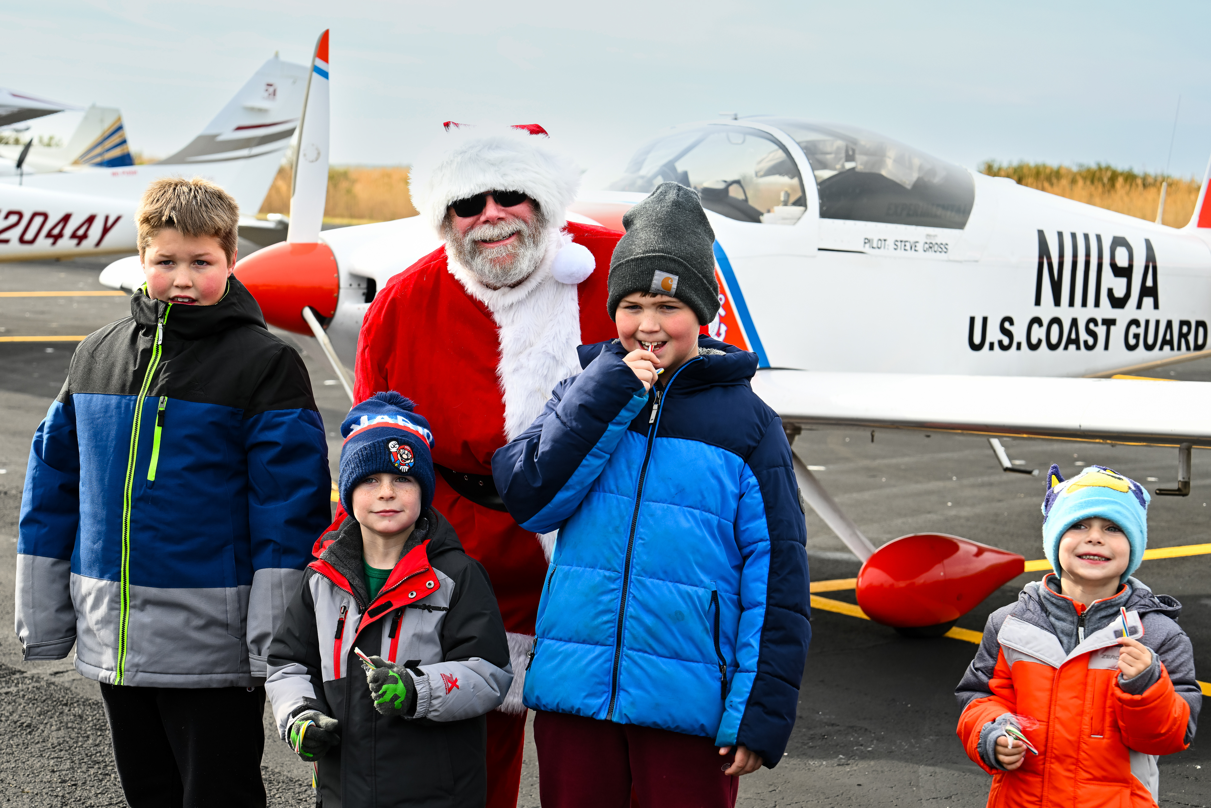 Santa Claus poses for a photo with children living on Tangier Island.  Photo by David Tulis.