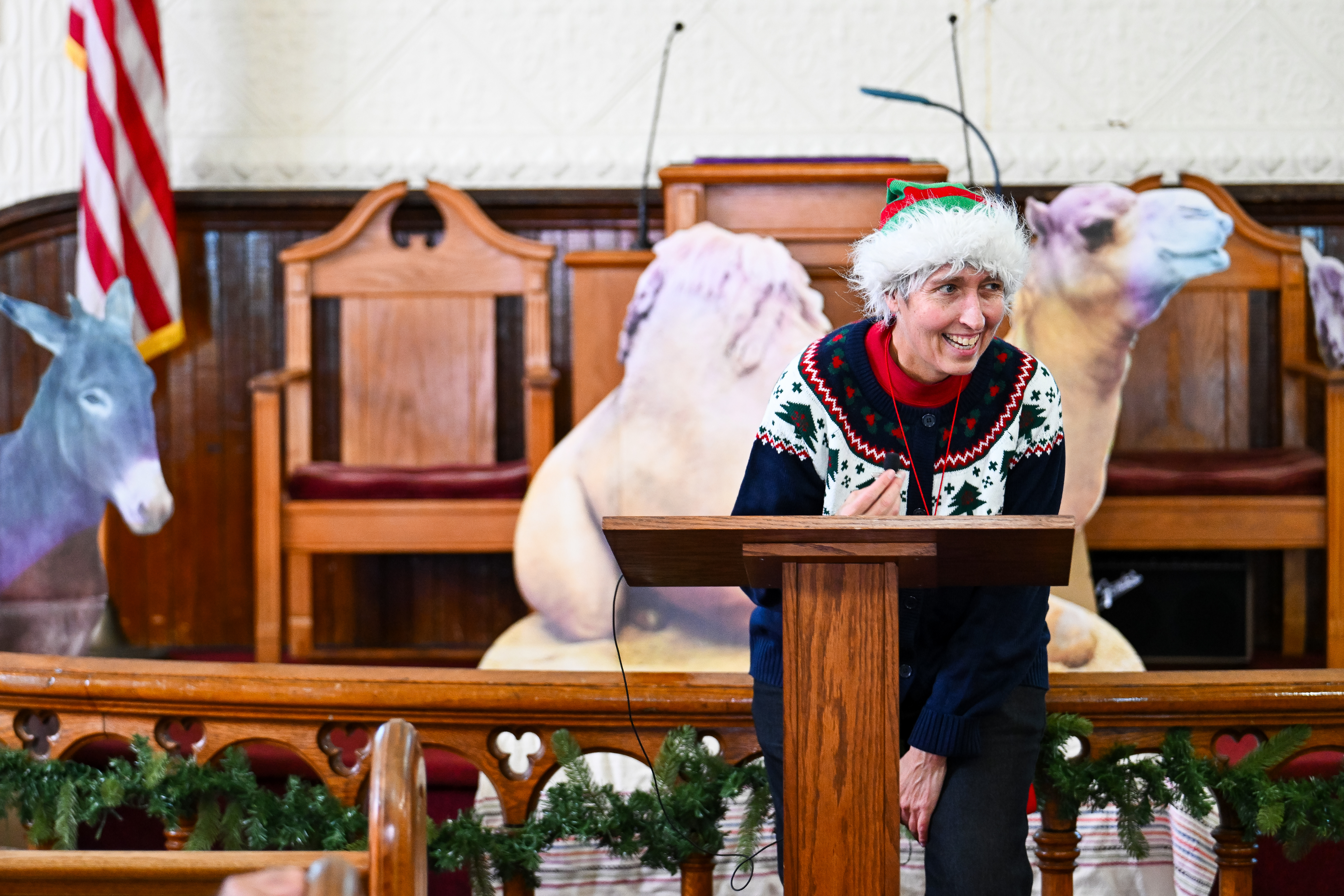 Chesapeake Sport Pilot owner and CFI Helen Woods is caught off guard as she is called to the pulpit at Swain Memorial Methodist Church on Tangier Island, Virginia, to say a few words about the 20 pilots and dozens of volunteers participating in the annual Tangier Holly Run. Photo by David Tulis.