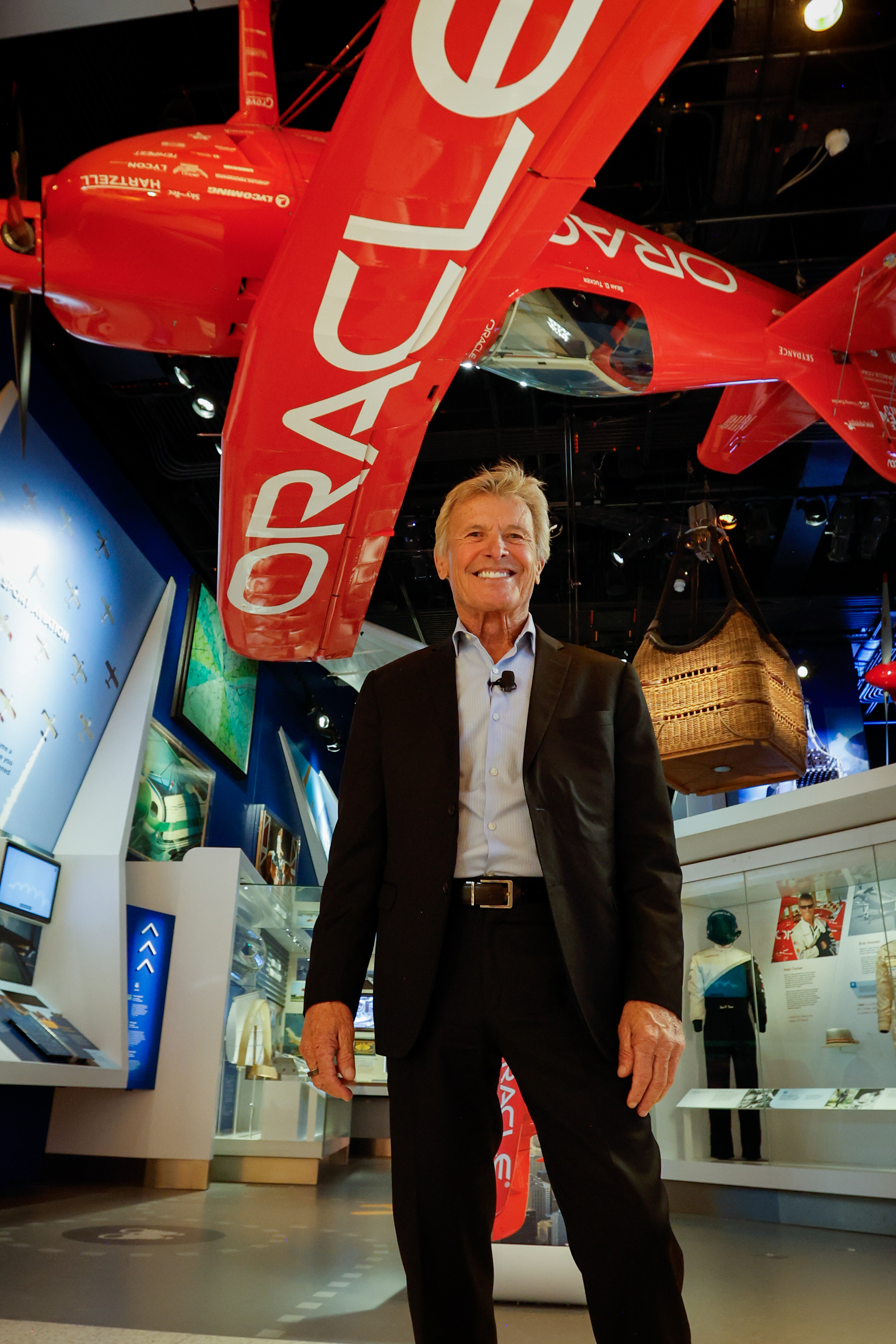 Airshow legend and master of ceremonies Sean D. Tucker posed in front of his Challenger III aerobatic biplane on display at the museum. Photo by Chris Rose