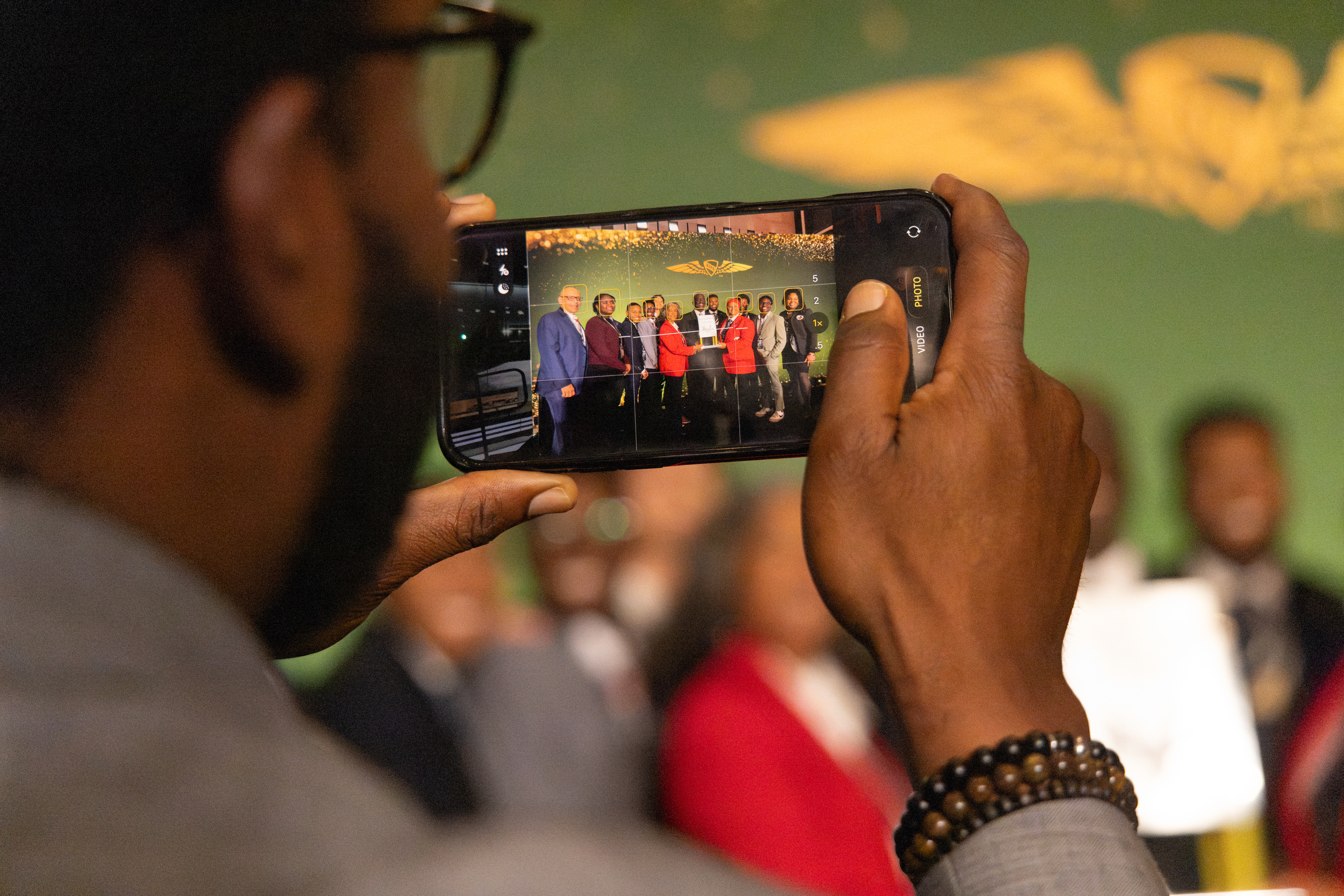 The celebration continued after the ceremony when Brigadier General Charles McGee Aviation Inspiration Award recipient Glendon Fraser posed for a photo with his family and friends. Photo by Rebecca Boone.