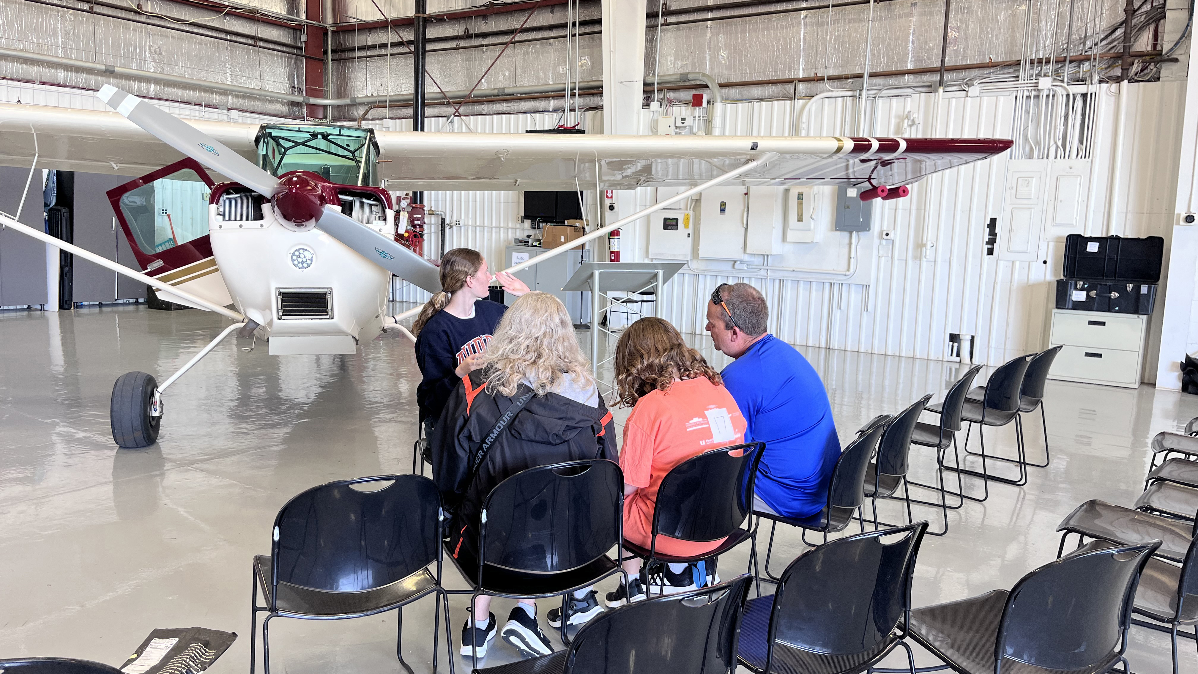 Maddie Allen briefs a family before their flight. Photo by Sylvia Horne.