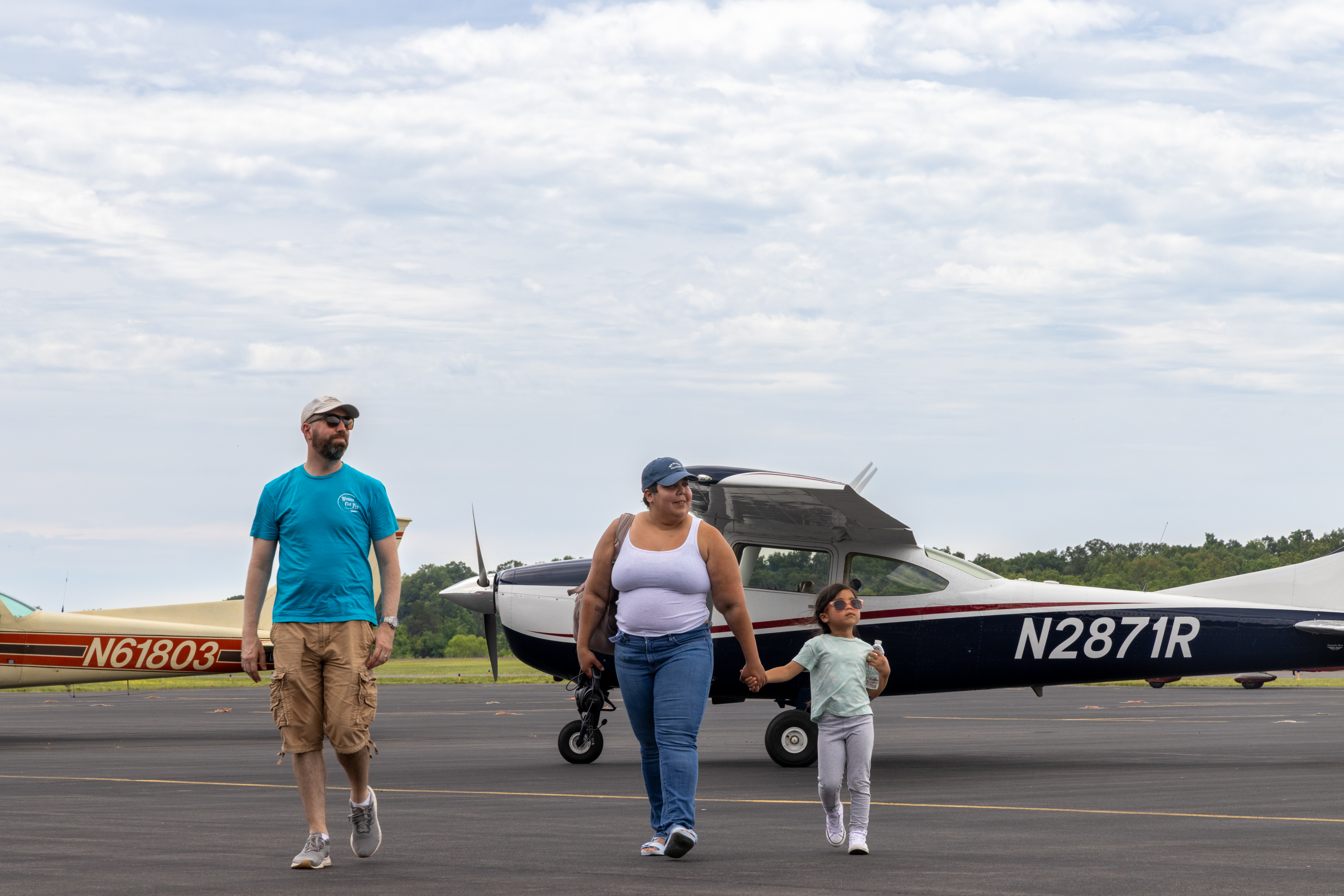 A volunteer escorts attendees through the aircraft on the tarmac. Photo by Rebecca Boone.