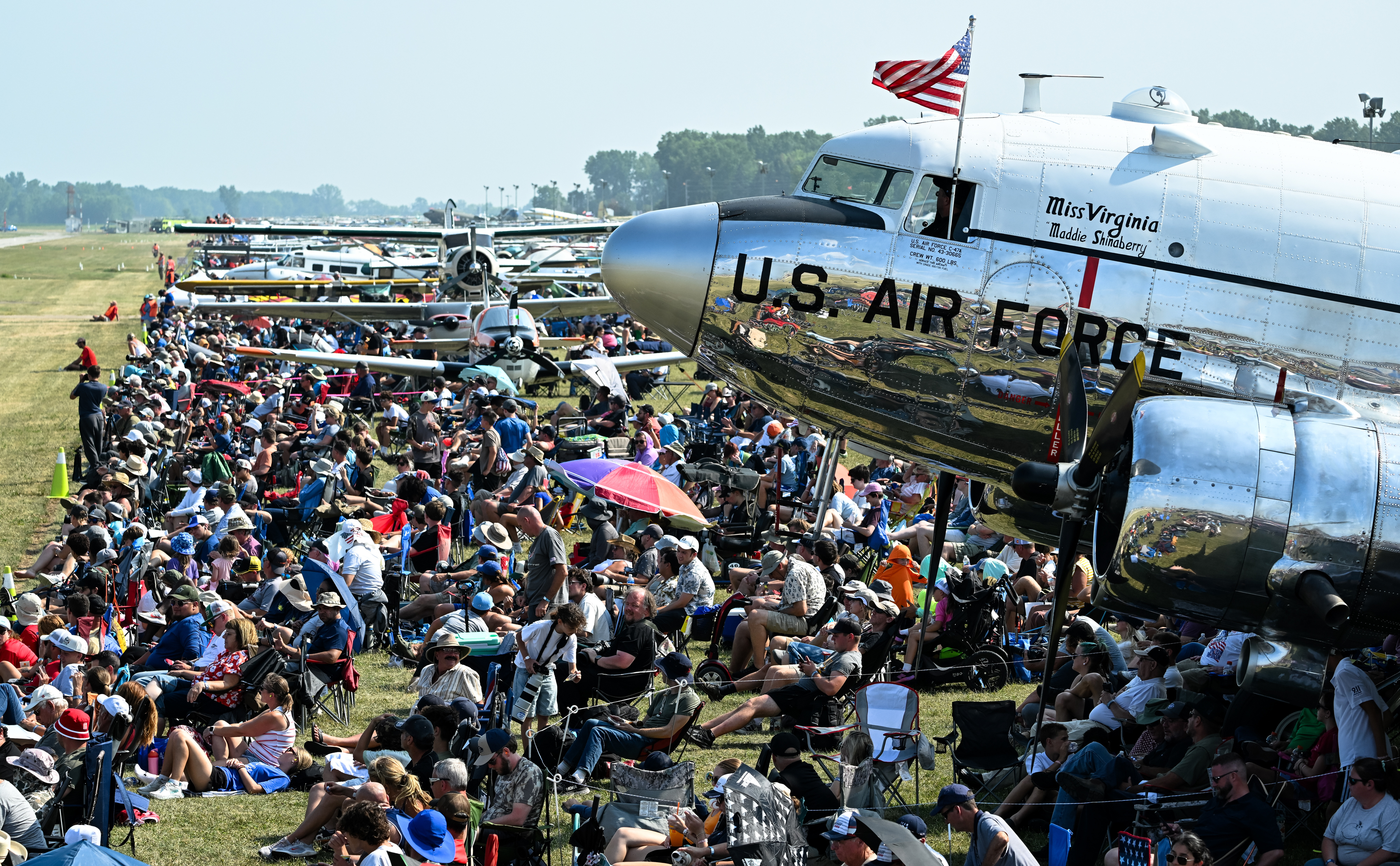 Airshow fans crowd the flight line in front of the polished fuselage of a Douglas C-47 named "Miss Virginia." Photo by David Tulis.