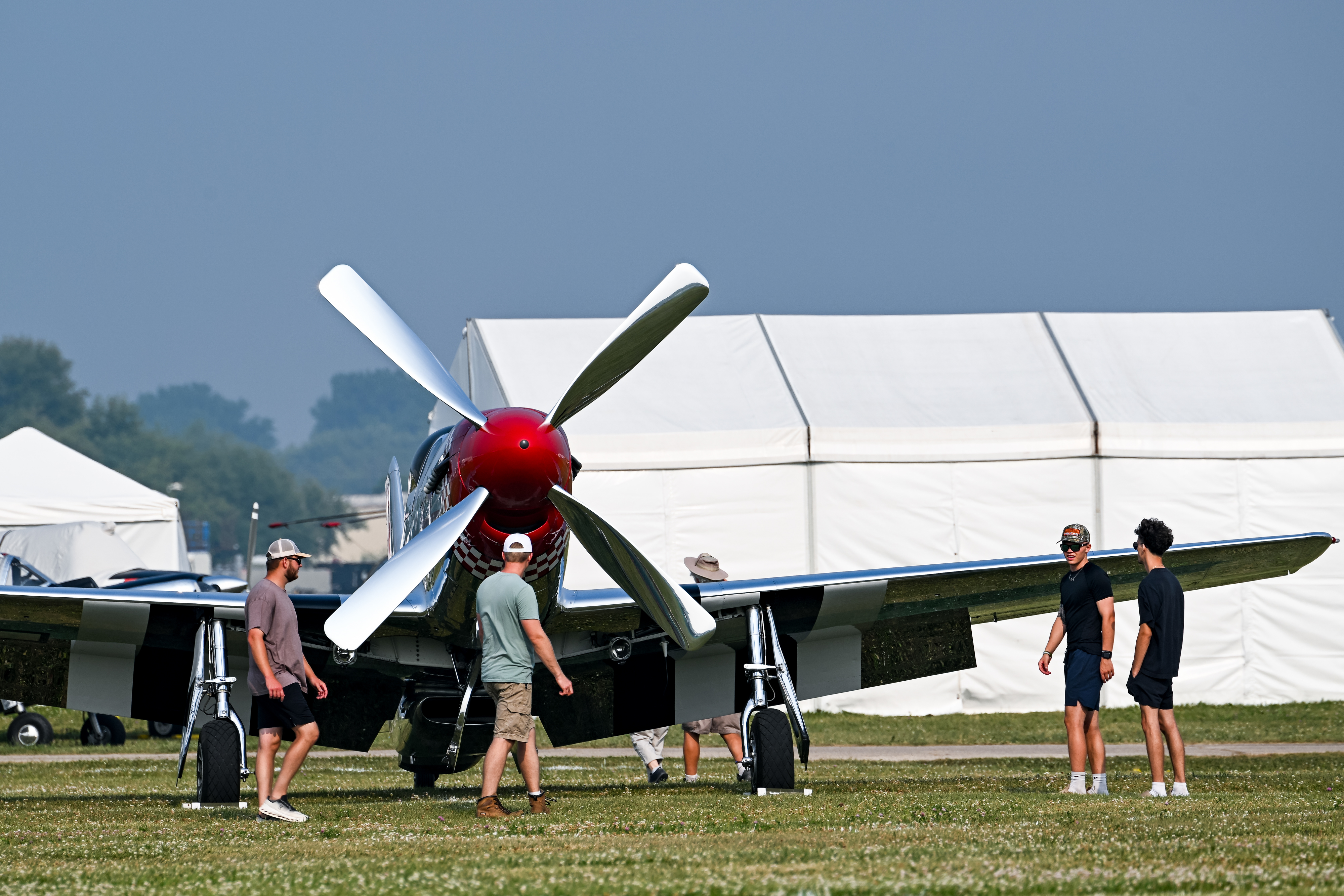 Airshow attendees inspect a North American P-51 Mustang, one of the early arrivals, on July 18. Photo by David Tulis.
