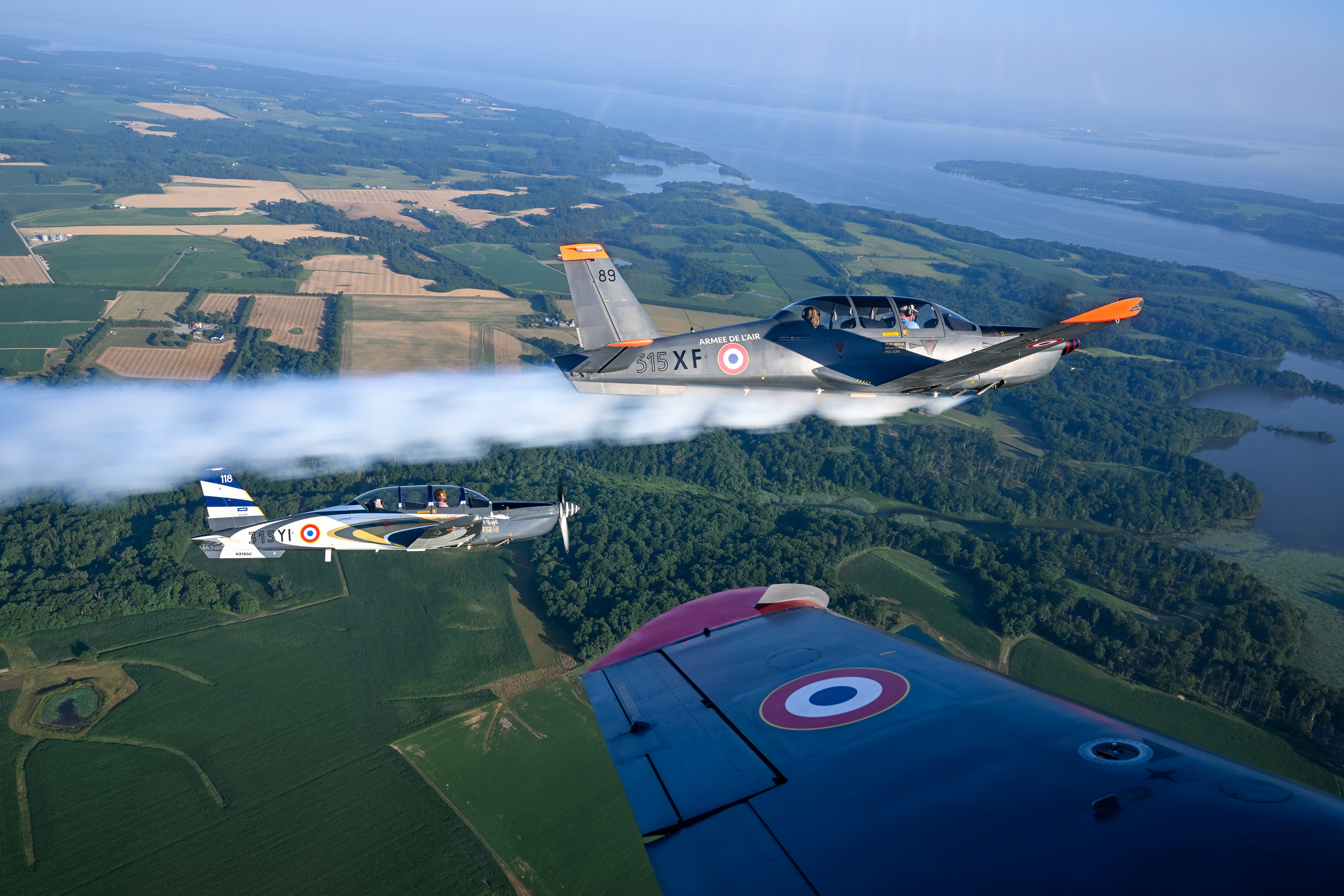 Socata TB30 Epsilon pilots fly with smoke on. Photo by David Tulis.