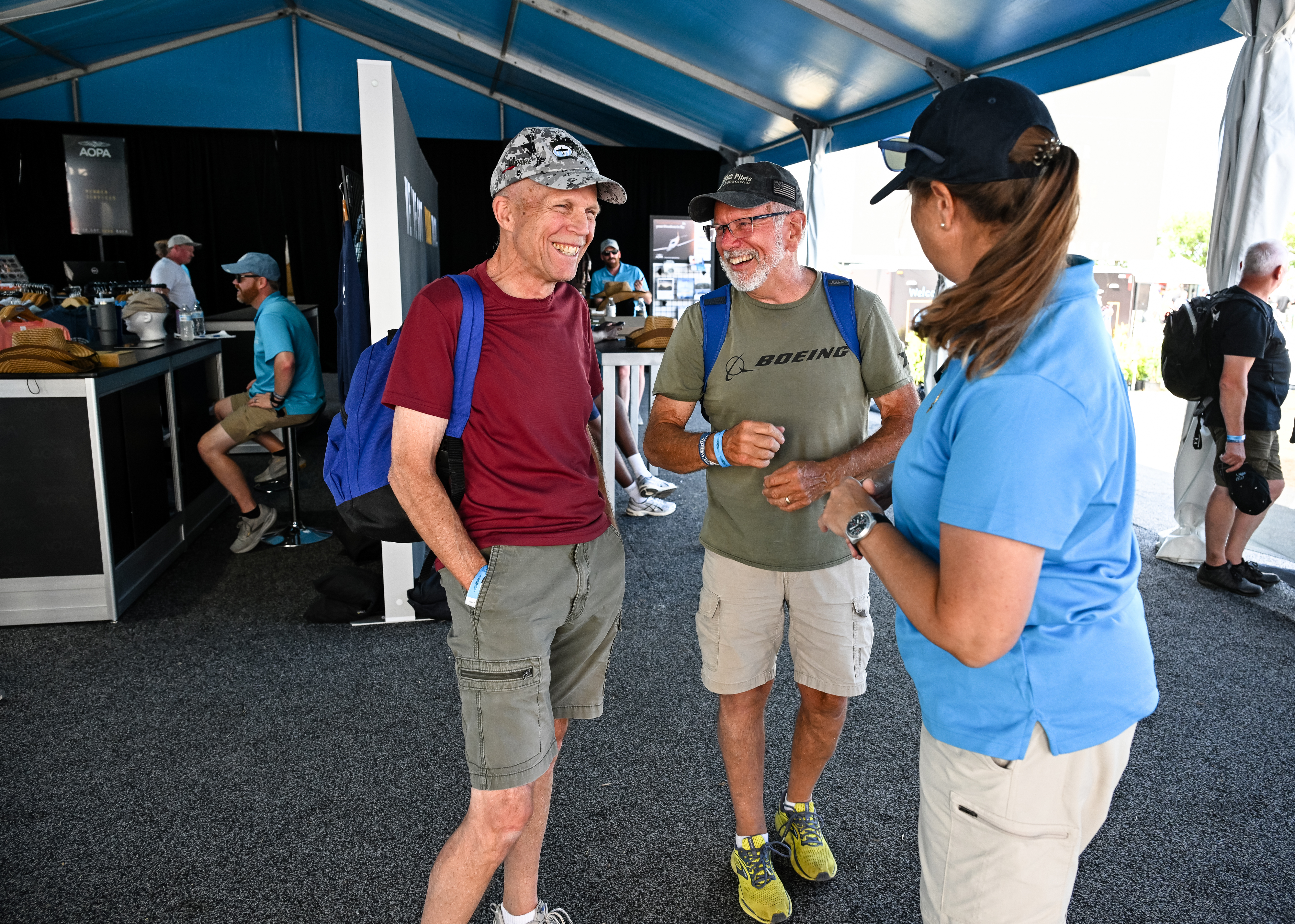 AOPA members socialize during a party thrown for members to watch the night airshow. Photo by David Tulis.