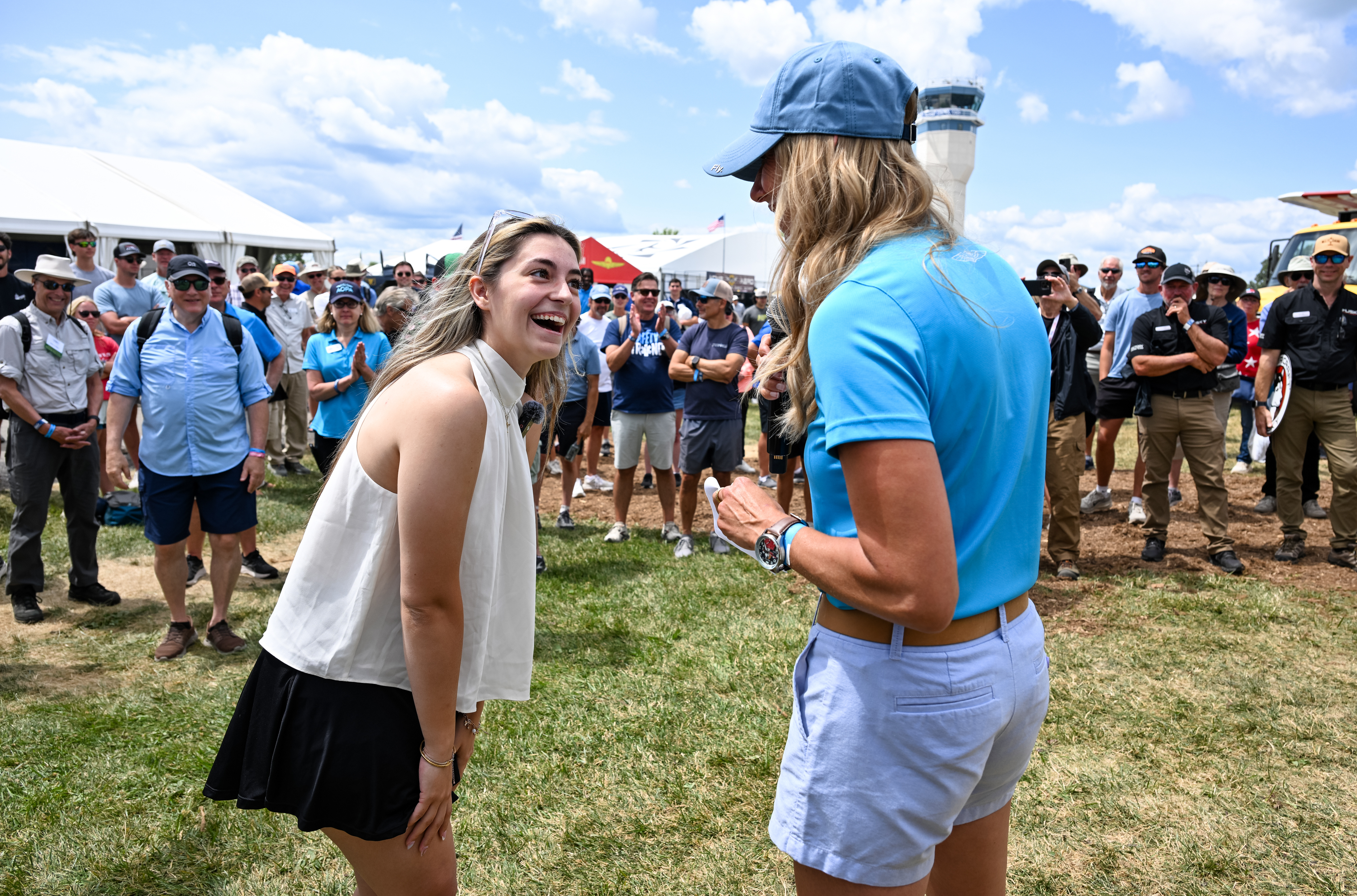 AOPA Sweepstakes Aviat Husky winner Ashley Almquist is surprised by a ruse that lured her to the AOPA Pilot Town Hall. Photo by David Tulis.