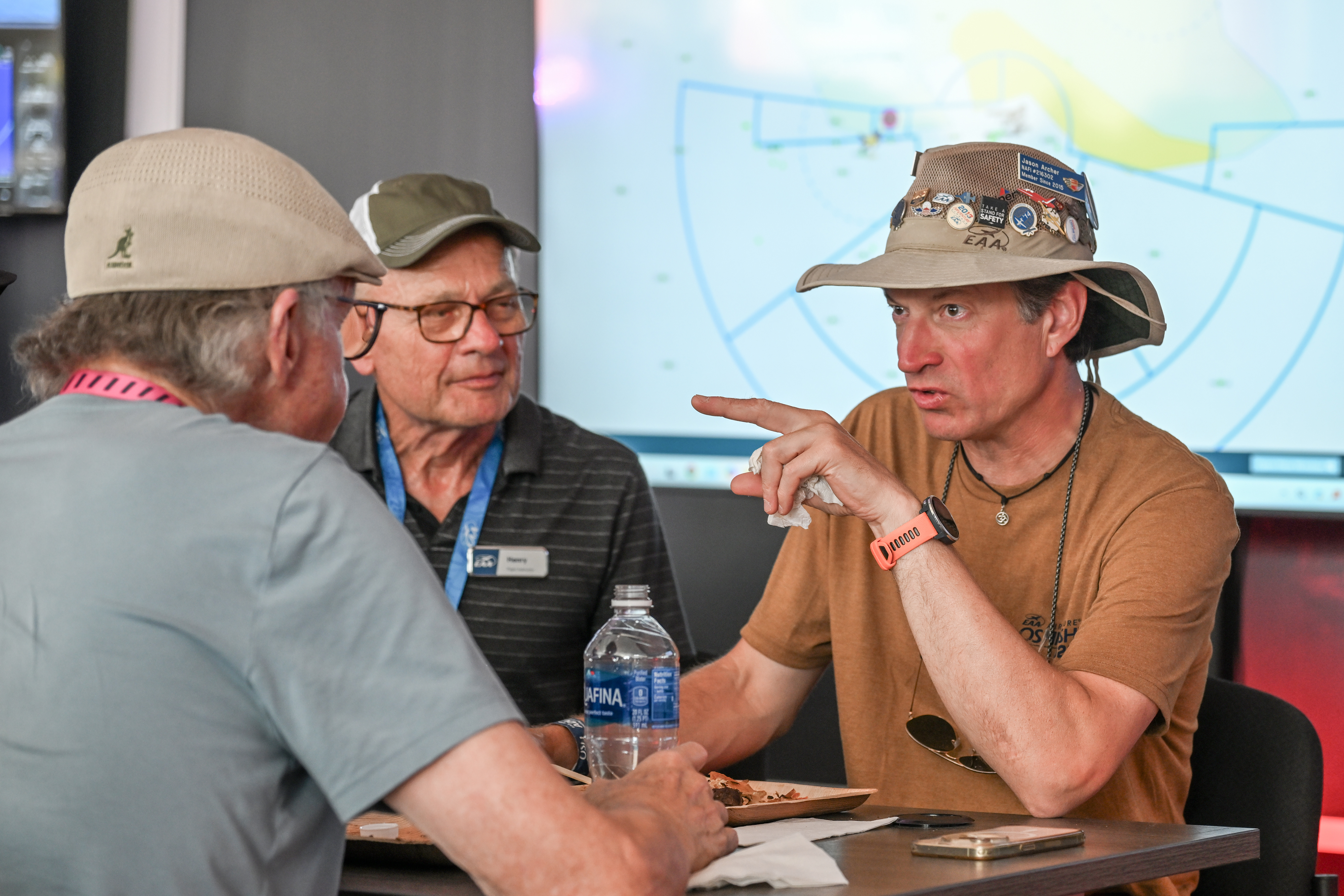 Flight instructor Jason Archer greets friends at the Redbird Flight Simulations welcome event. Photo by David Tulis.