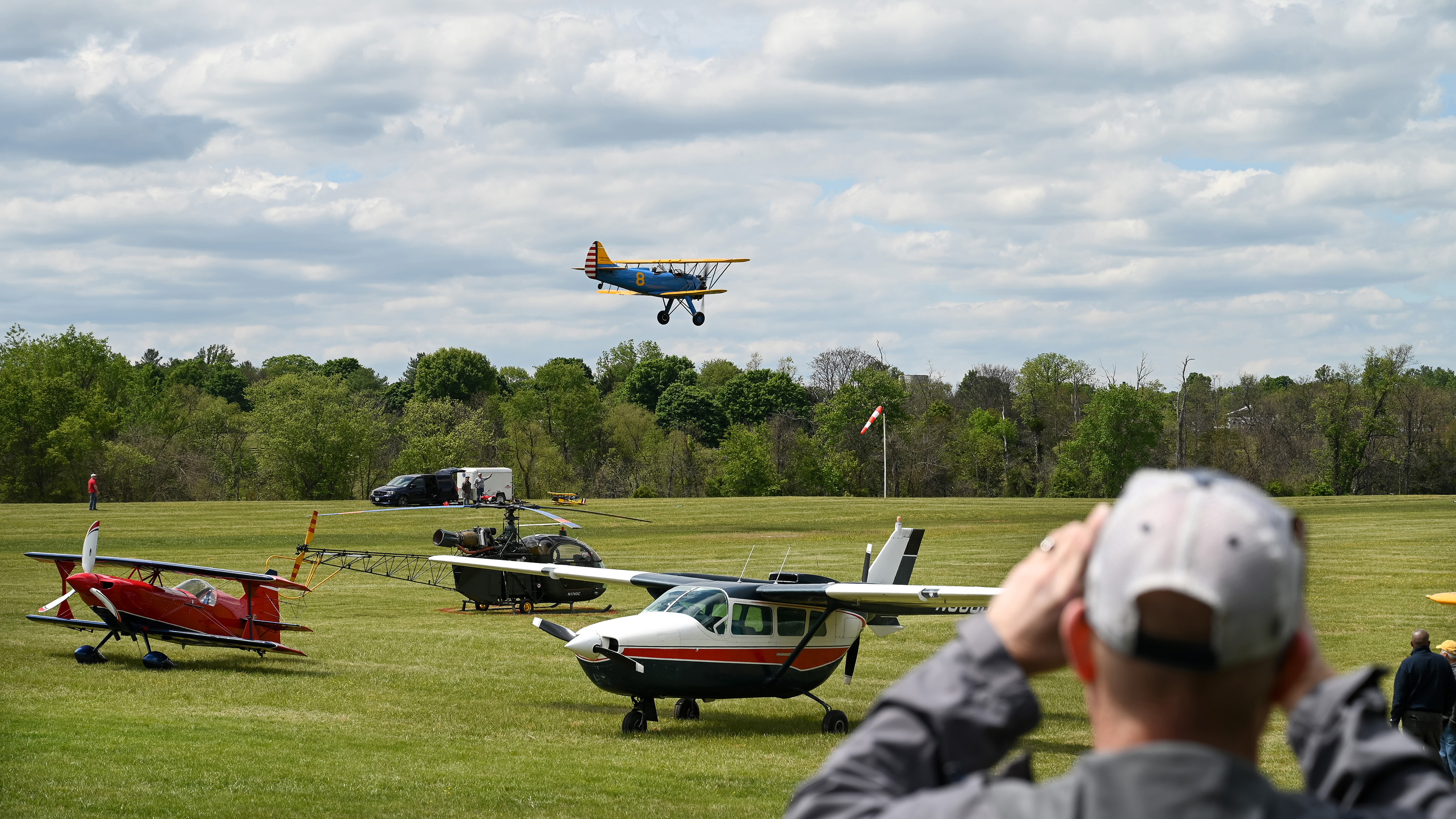 A biplane lands at the Horse Feathers grass airstrip. Photo by David Tulis.