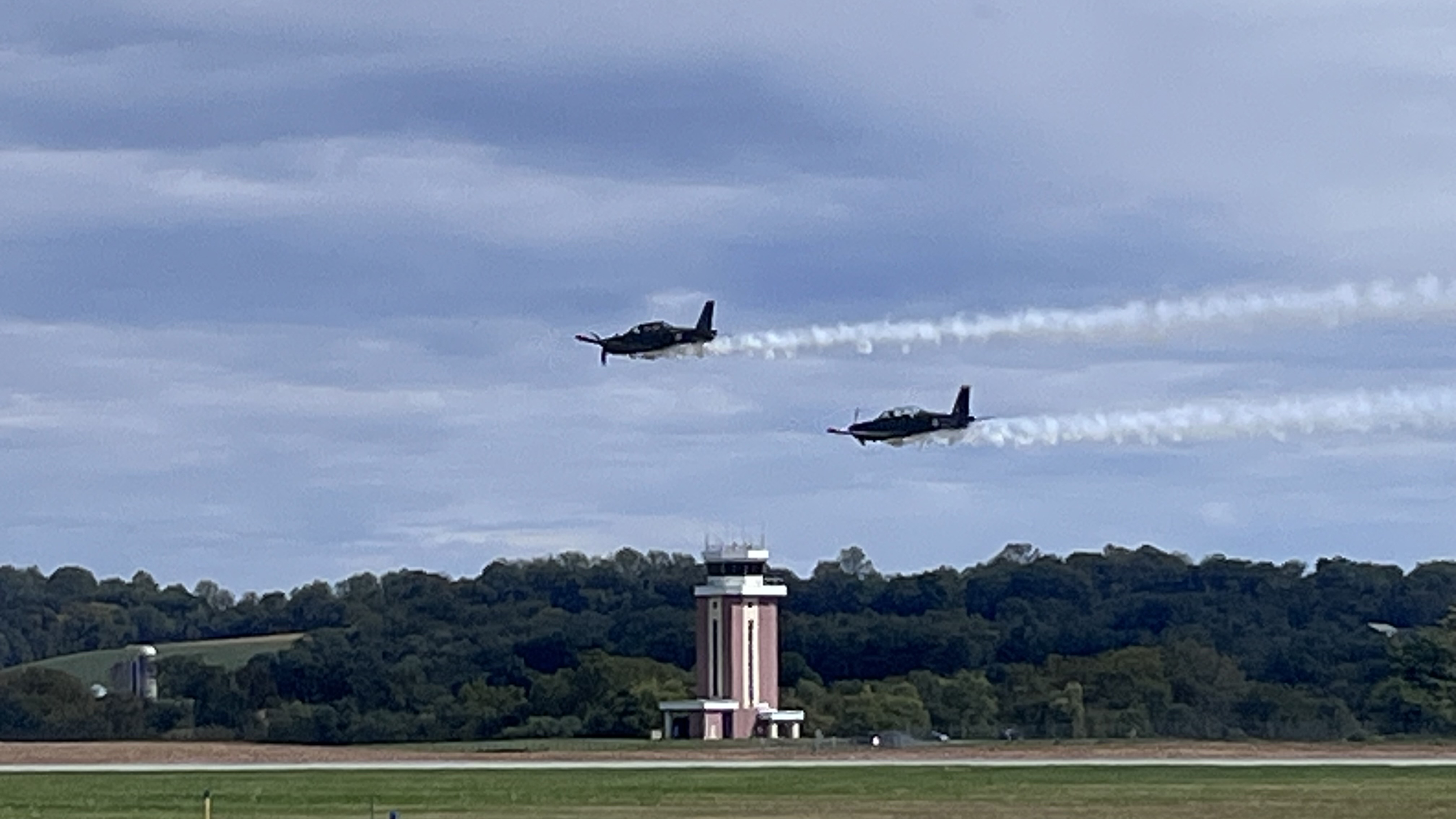Two T-6s flying by with smoke on. Photo by Sylvia Horne. 