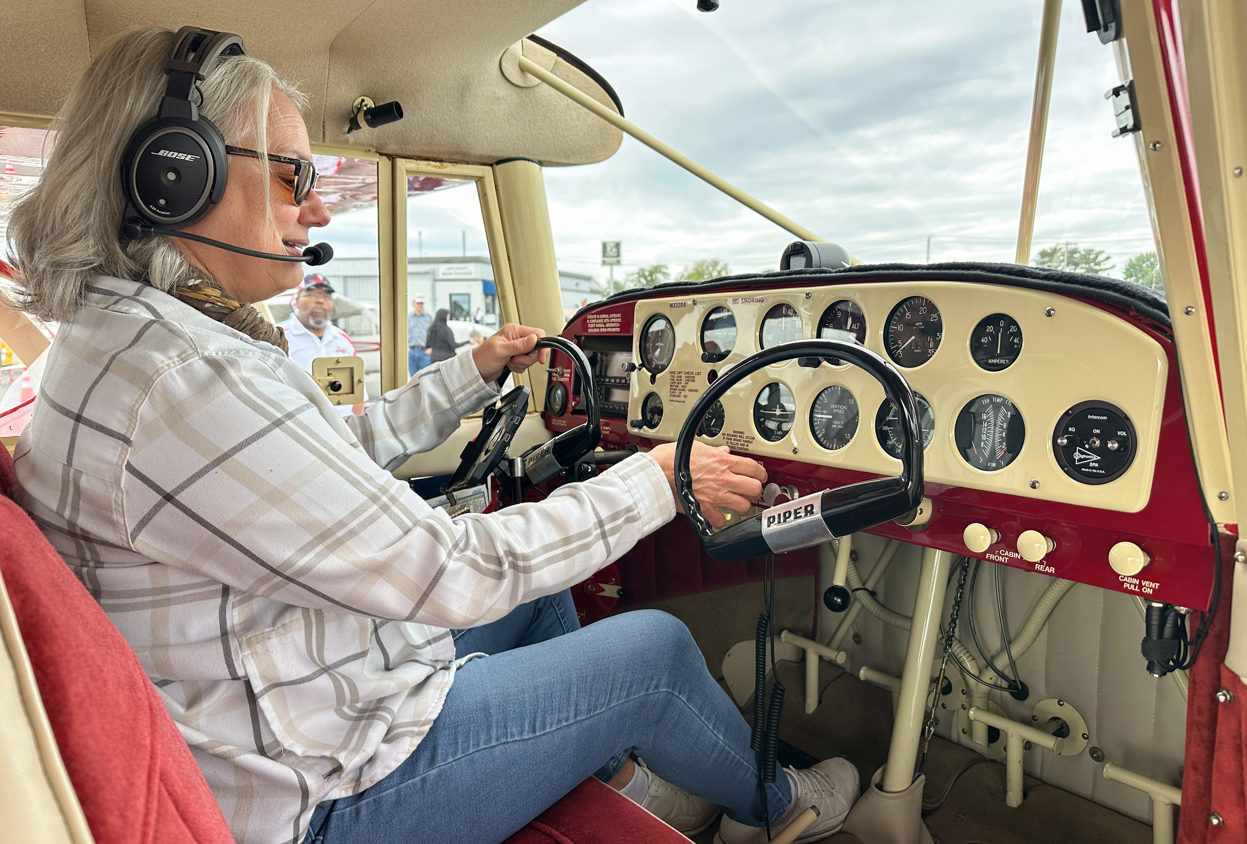 A visitor explores the Piper Tri-Pacer on display. Photo by David Tulis.
