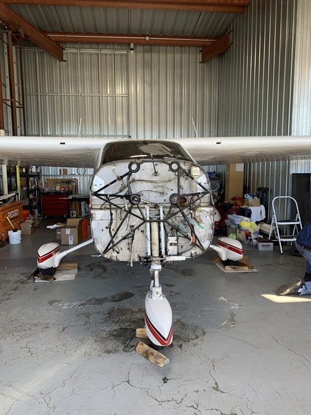 The owner of this Cessna Cardinal was able to get the engine reinstalled in time to relocate the aircraft to a nearby airport under its own power following the rent increase imposed by Denver jetCenter this year that has left many of these hangars sitting empty. Photo courtesy of Chris Stieber.