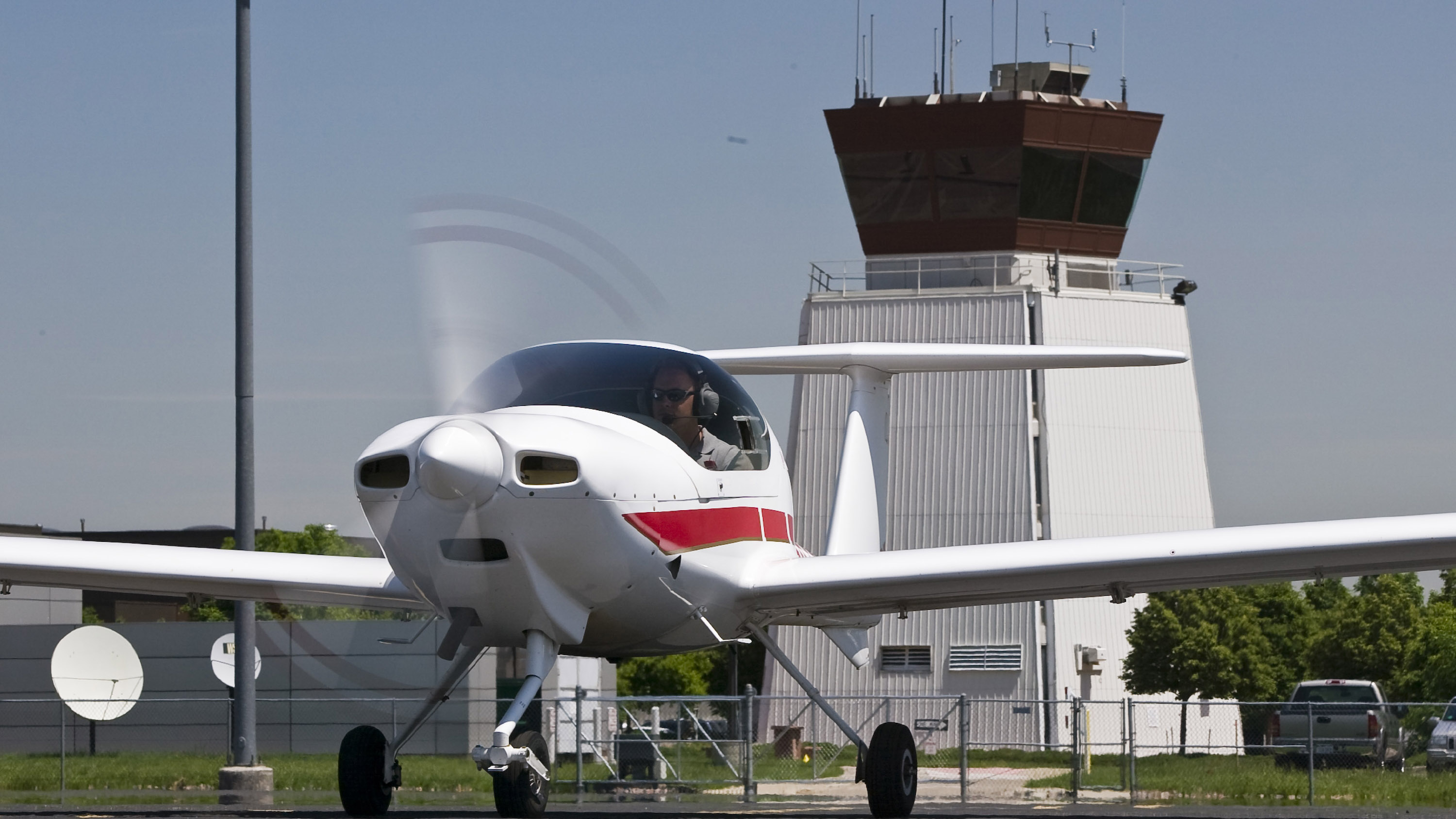 Airports may some day be controlled remotely, not from the familiar control towers on airport premises like this one. Photo by Mike Fizer.