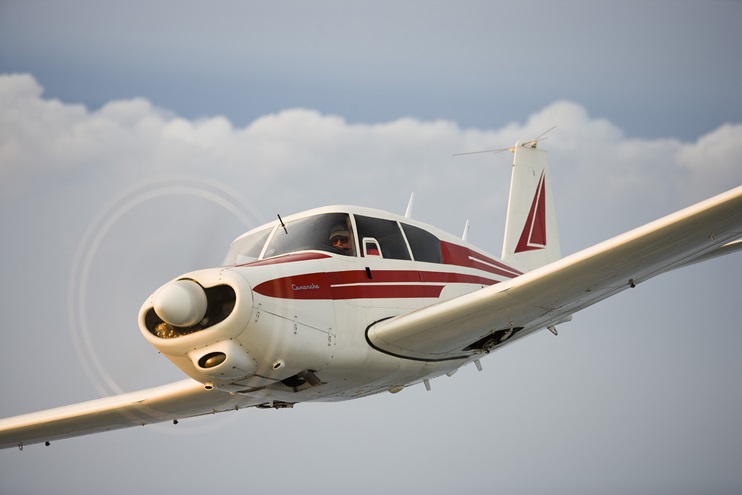 A 1961 Piper Commanche 180 flies over the Maryland countryside. Photo by Mike Fizer.