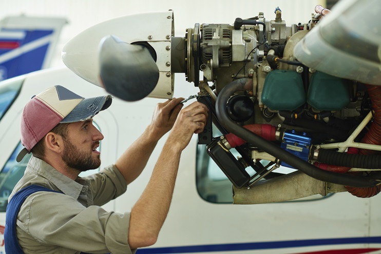A mechanic repairs a small aircraft. iStock photo. 
