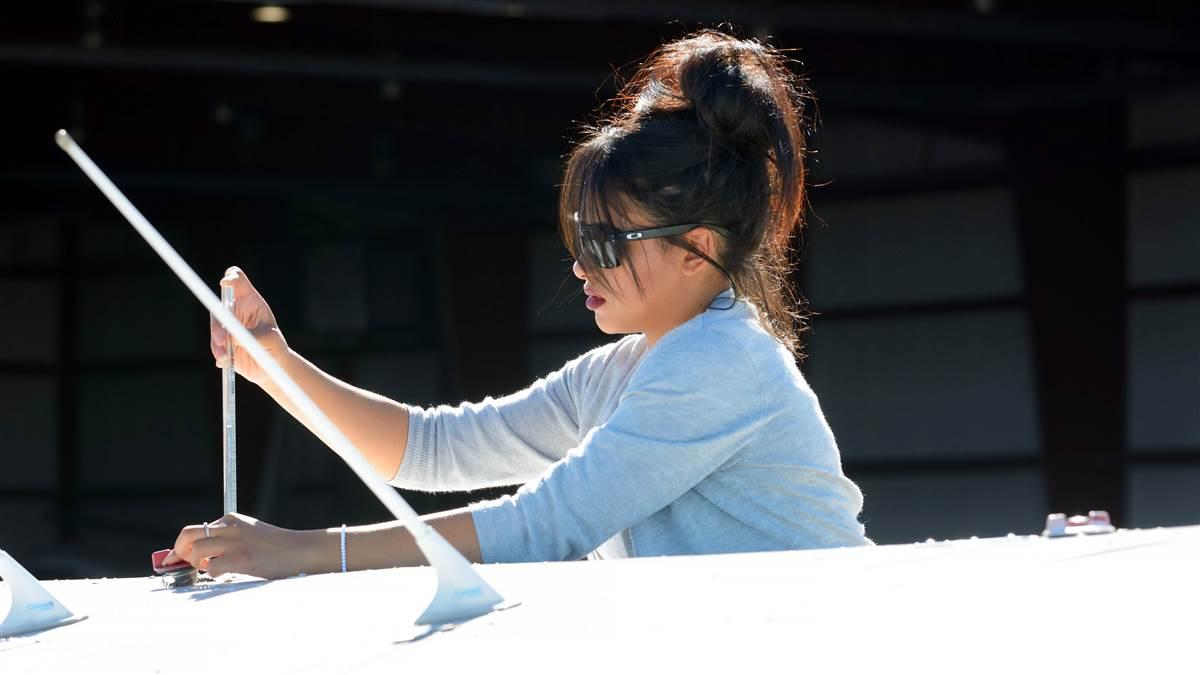 Student Jeludy Camacho checks the fuel before a flight lesson.