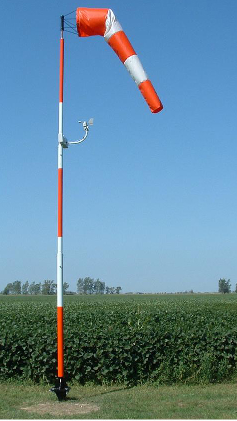 An anemometer is another device that measures the speed of the wind. This anemometer is part of a weather station mounted to the windsock pole