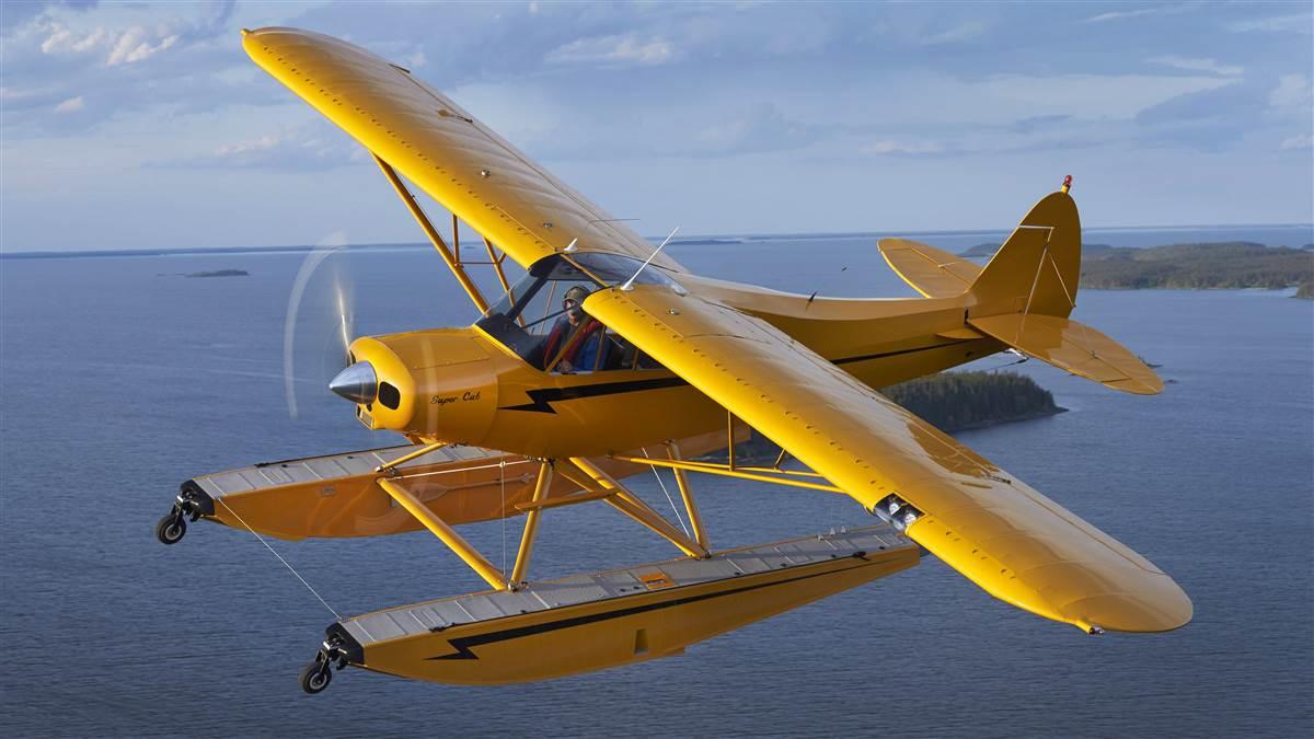 Photography of Seaplanes Adventures float plane tour up to Churchill, Manitoba, Canada for Lazy Bear Expedition's outings for polar bear and Beluga whale spotting. Shown is AOPA President, Mark Baker's Super Cub on floats flying over God's Lake near the Elk Island Lodge.
 
God's Lake
Elk Island Lodge, Manitoba  Canada