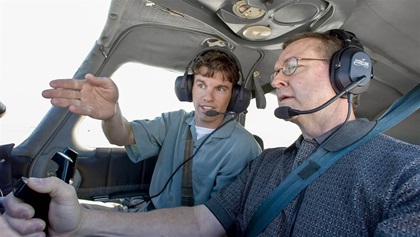 Photography of a young instructor and an older student in the cockpit of a Piper Cherokee.Wichita, KS   USA