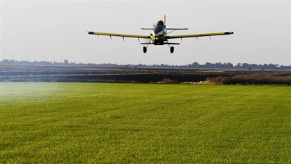 Farm Air agricultural pilots Juston Staas and Will Cannon spray rice growing in the fertile Sacramento Valley downstream of the Oroville Dam in Sacramento, California. Farm Air deploys turbine fixed wing and rotary wing aircraft. Photo by David Tulis.