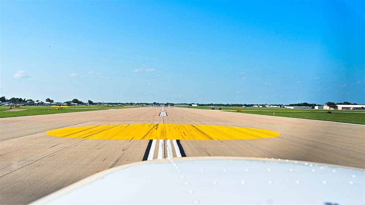 Landing on this yellow dot begins by controlling the final approach speed. Then pick an aiming point a few hundred feet short of the dot and use it as the reference point when flying downwind, base, and final approach. Photography by David Tulis.