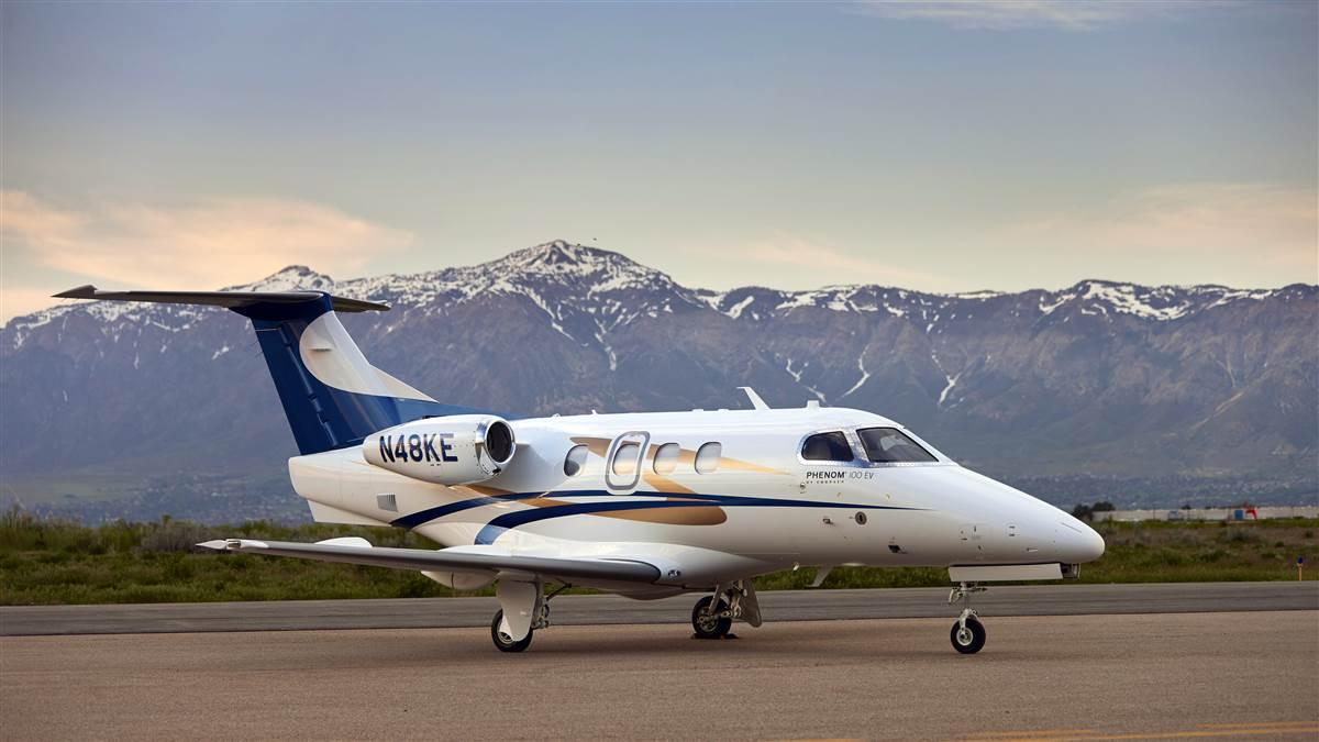 The Phenom 100EV has four cabin windows per side and a straight wing with deice boots.
