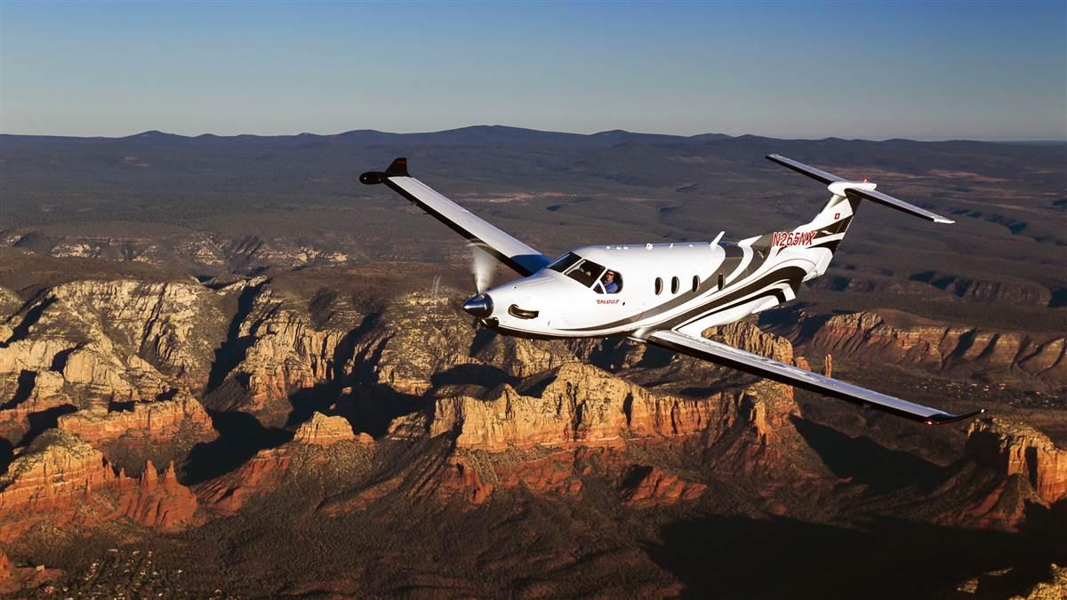 Look for composite, five-blade scimitar propeller; winglets; radar pod on right wing; five cabin windows on right side, four on left. That big aft door.