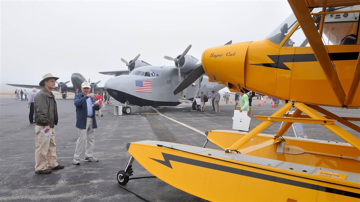 A Douglas C-47, a Grumman Albatross, and a Piper Super Cub are displayed at show center Saturday morning, Oct. 7, during AOPA's 2017 Groton Fly-In. Photo by Mike Collins.