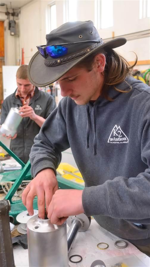 Dylan Cox, in hat at right, is a mechanic’s helper; Josh Schlosser is an A and P.