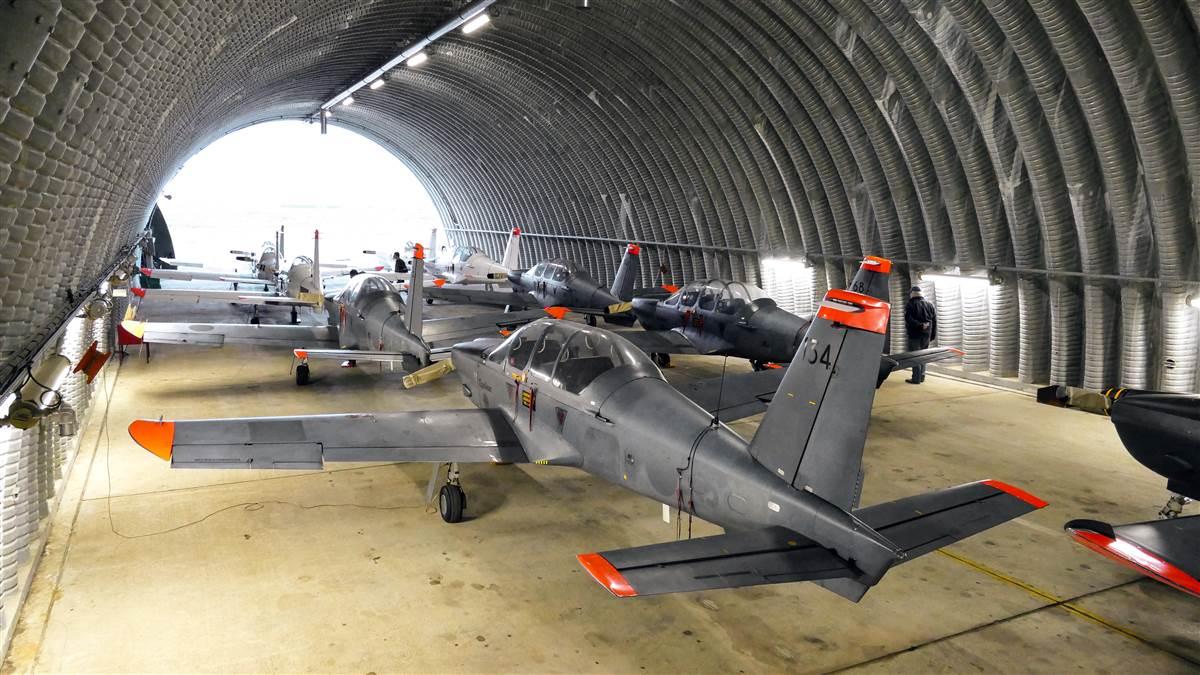 The pilots get a look at their lot of 19 Epsilons, retired from the French military and kept in a climate-controlled hangar. Ten of the airplanes were then disassembled in the hangar for transport to the United States.