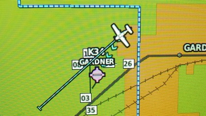 A subtle line of arrows on the multifunction display continuously flows toward the nearest airport that is within gliding range—Gardner Municipal Airport, in this case.