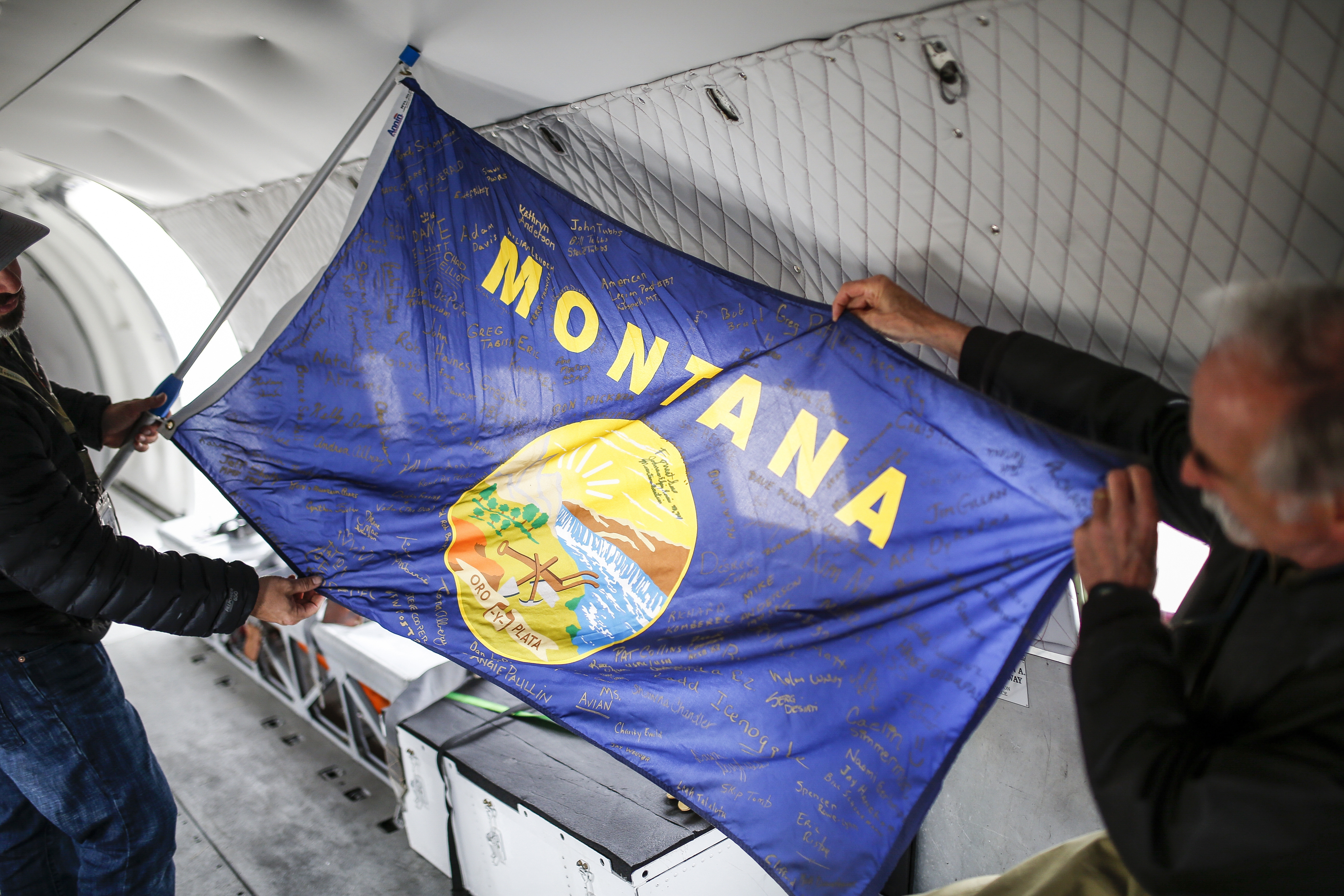Volunteers who worked on the restoration of 'Miss Montana' signed a state flag that flew over the airplane in Duxford and was carried by paratroopers during the anniversary jumps in Normandy.
