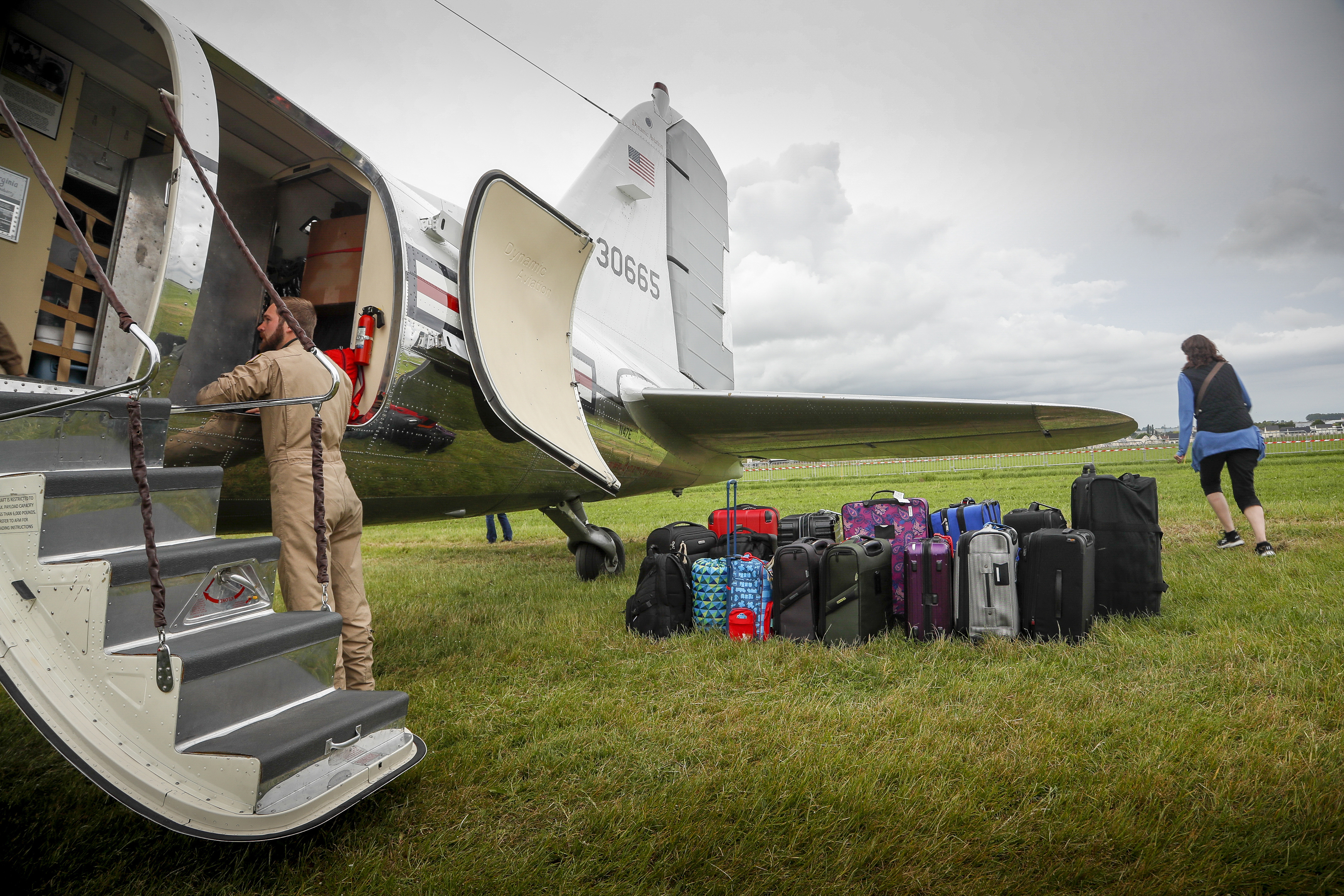 These airplanes may be nearly 80 years old, but they still carry a load. 'Miss Virginia' packed in 17 people and a pile of bags for the crossing to Normandy.