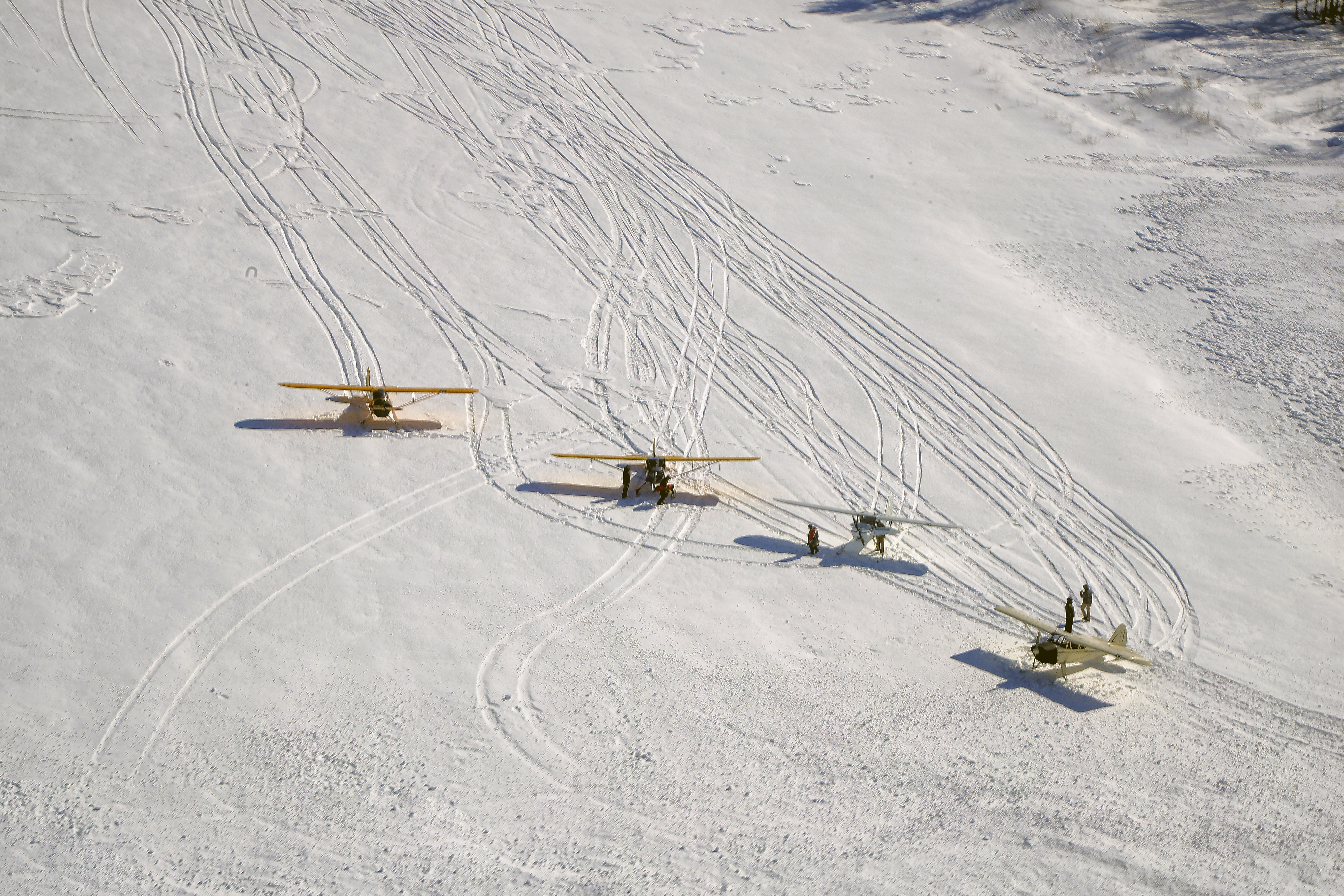 Skiplane pilots make tracks in the crusty snow atop Moosehead Lake, where the ice was 3 feet thick.