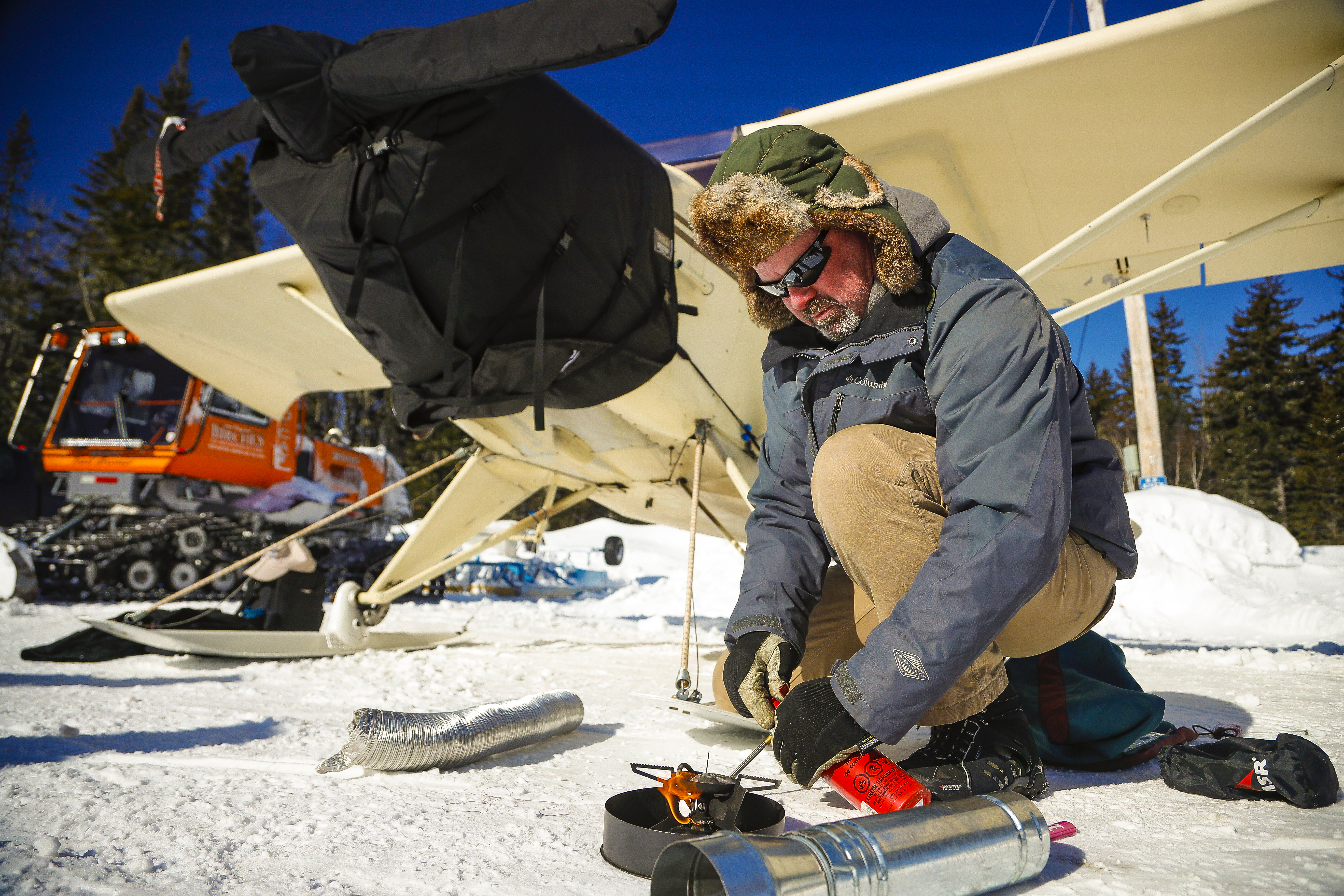 A winter preflight inspection includes heating the engine compartment with a propane stove.