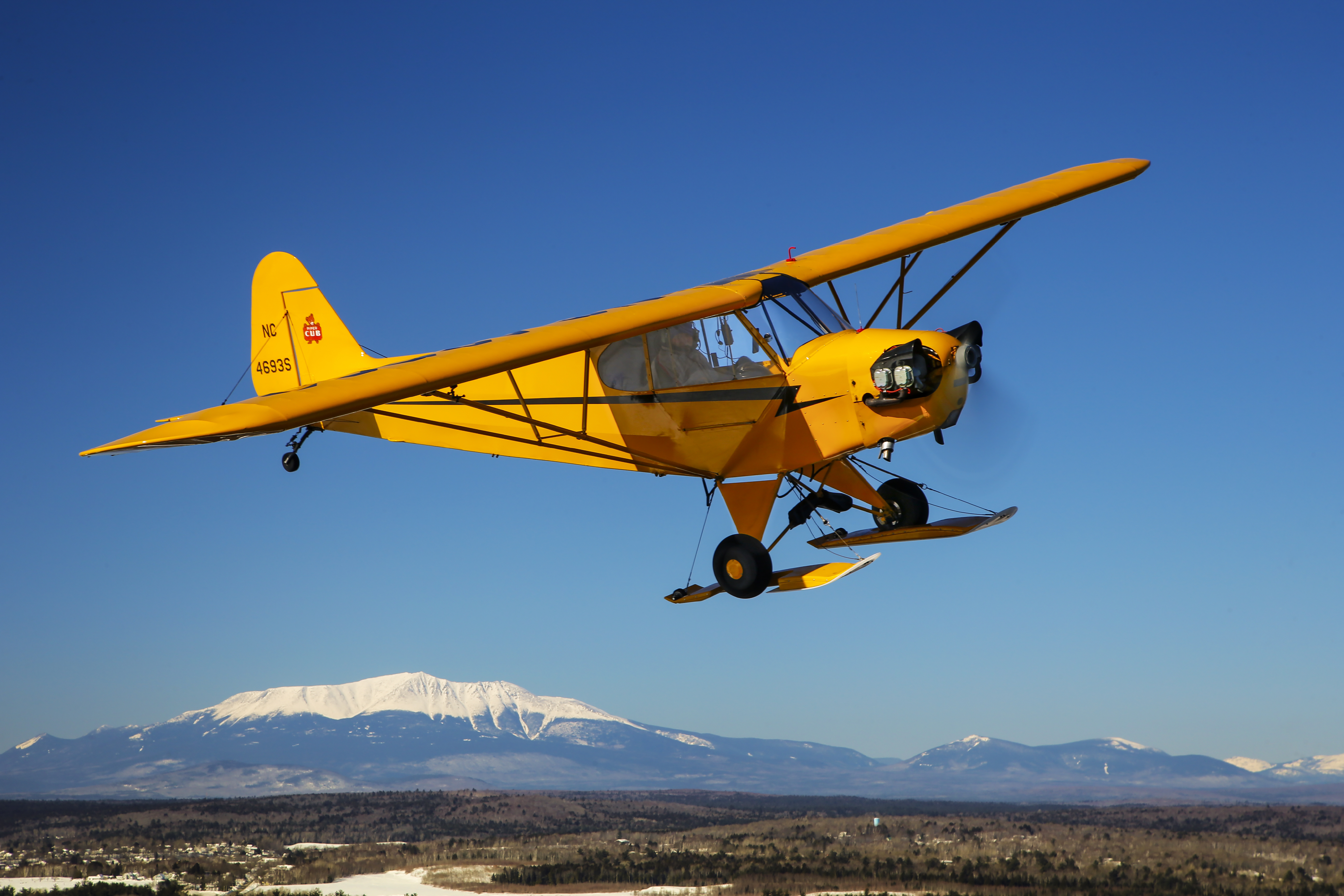 Kirk Wicker flies his Piper J–3 over Millinocket, Maine, near Mount Katahdin, the state’s highest peak at 5,269 feet.